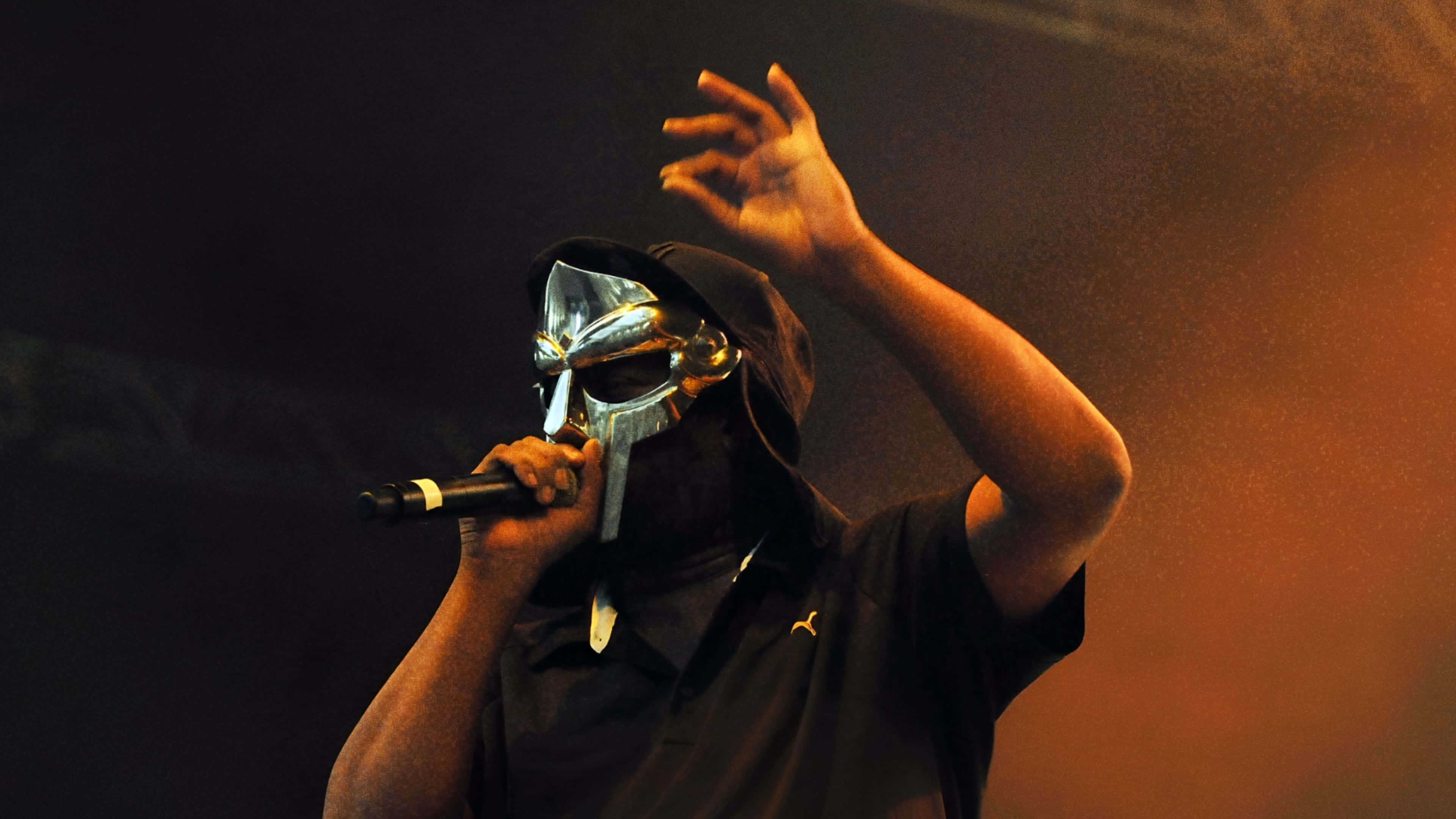 M F Doom, silver Spartan helmet, warm stage lights, 4K Desktop Wallpaper