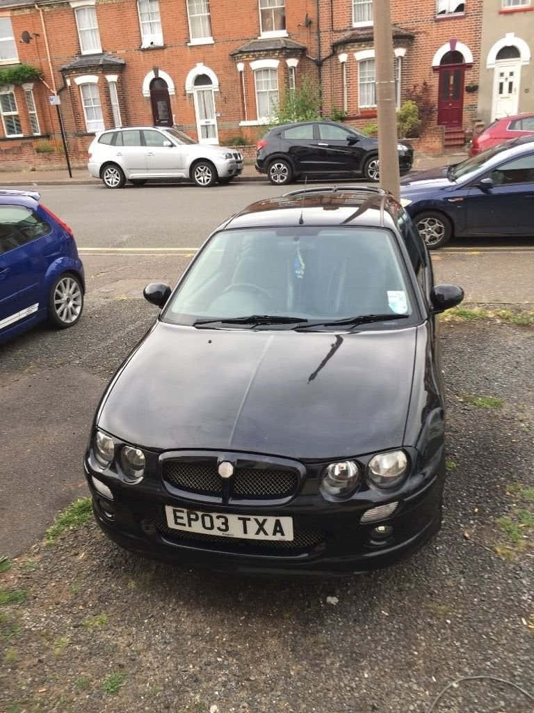 black MG ZR, gravel roadside, brick terraced houses, SD Phone Wallpaper