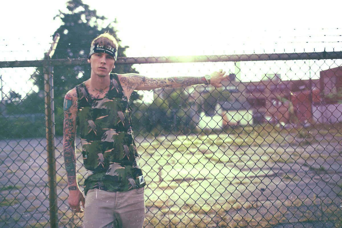 MGK, camouflage tank top, chain-link fence, SD Desktop Wallpaper