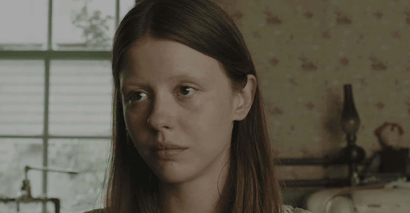 Mia Goth, long brown hair, dimly lit room, HD Desktop Wallpaper