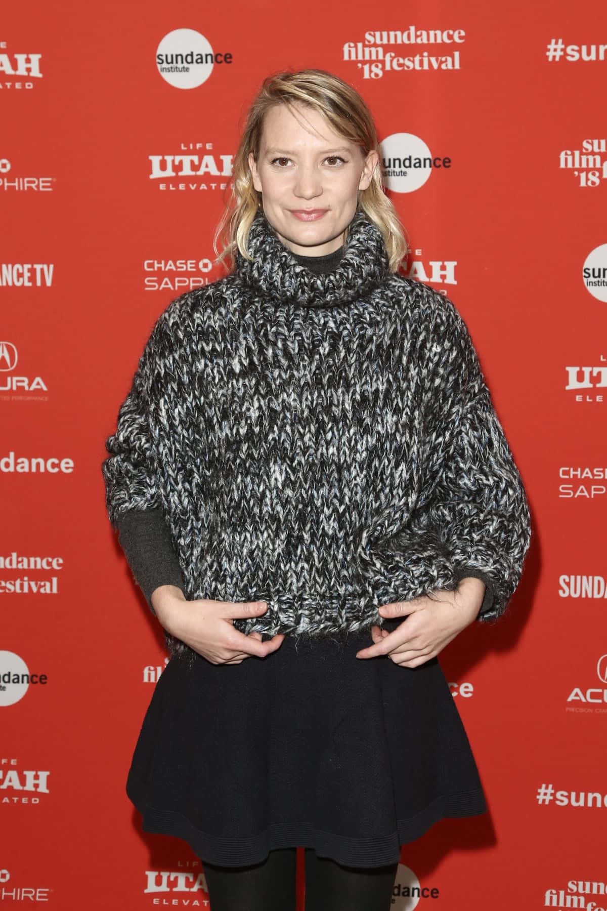 Mia Wasikowska, chunky black and white knit sweater, vibrant red Sundance Film Festival backdrop, HD Phone Wallpaper