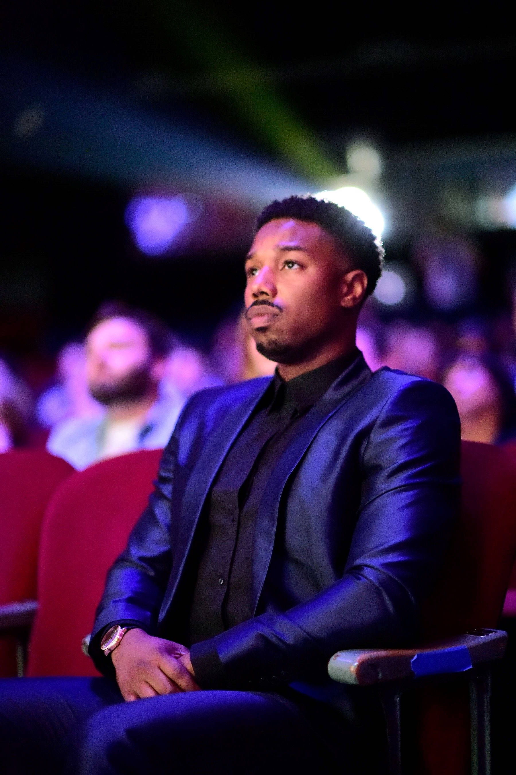 Michael B Jordan, black suit, dimly lit theater, 2K Phone Wallpaper