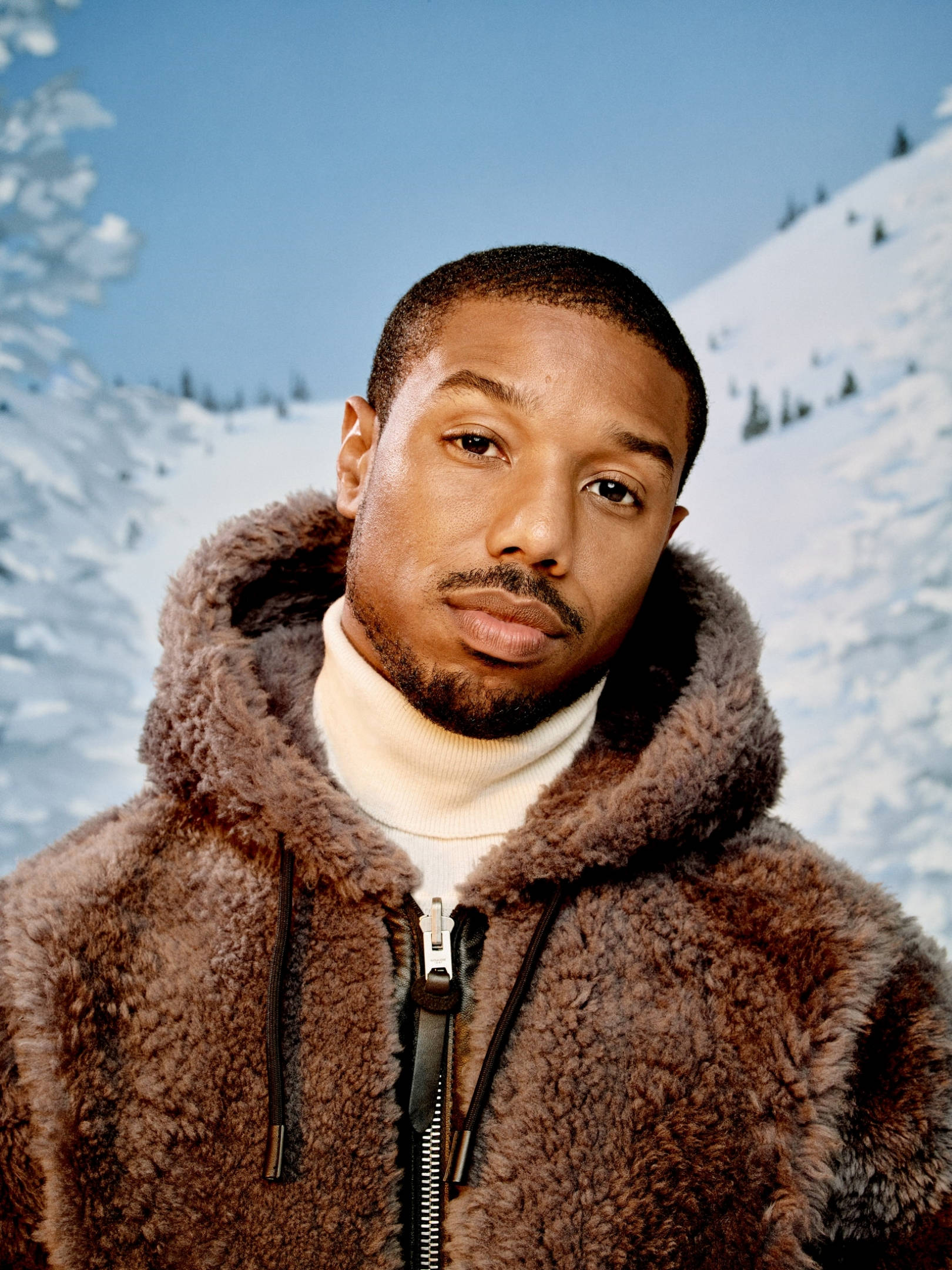 Michael B Jordan, brown fur-lined jacket, snowy mountain backdrop, Full HD Phone Wallpaper