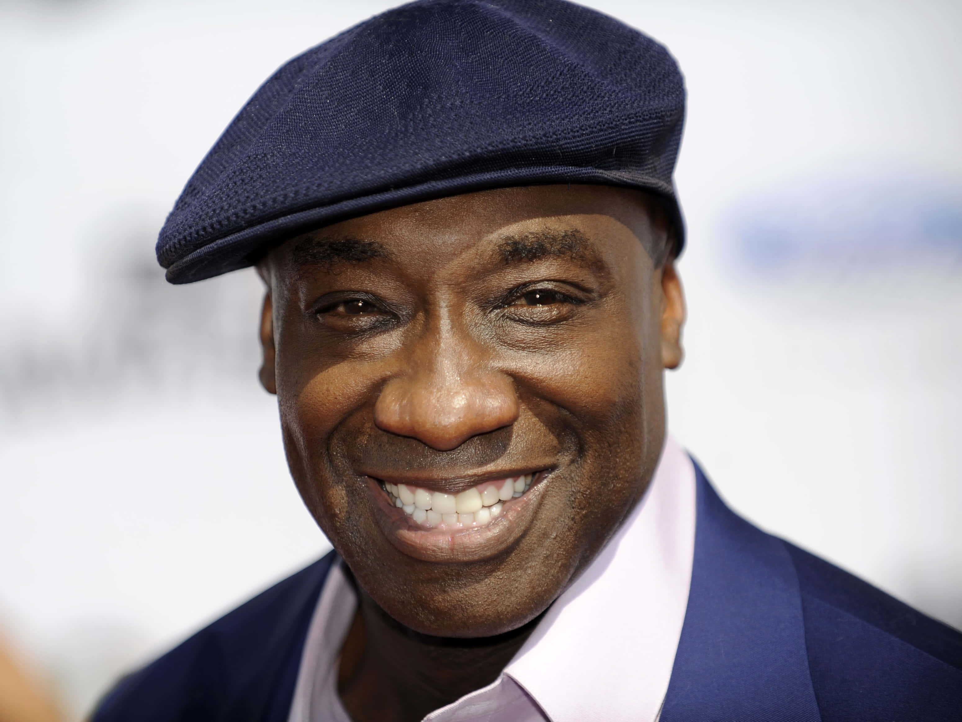 Michael Clarke Duncan, navy blue flat cap, light pink shirt, 2K Desktop Wallpaper