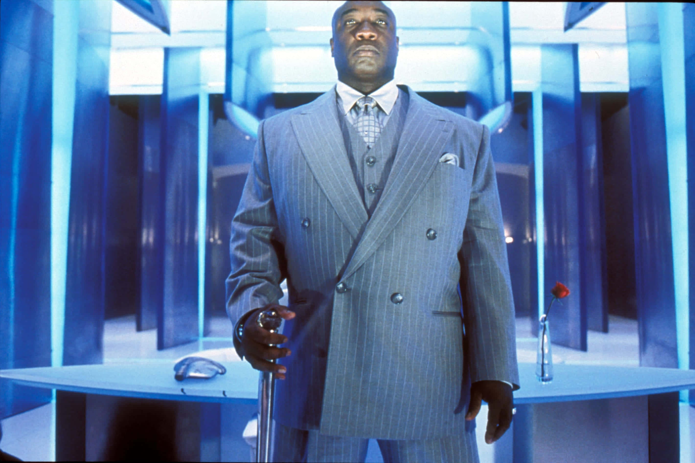 Michael Clarke Duncan, pinstripe suit, futuristic blue-lit corridor, 2K Desktop Wallpaper