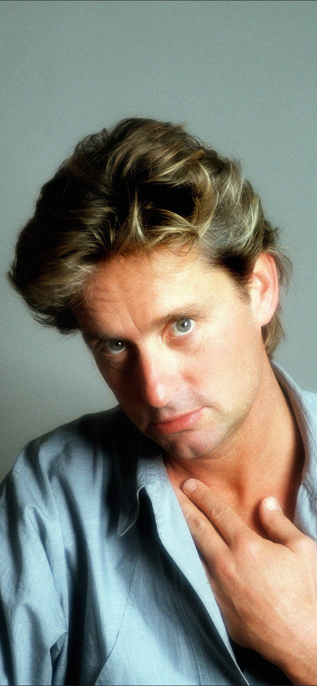 Michael Douglas, tousled blonde hair, intense blue eyes, 2K Phone Wallpaper