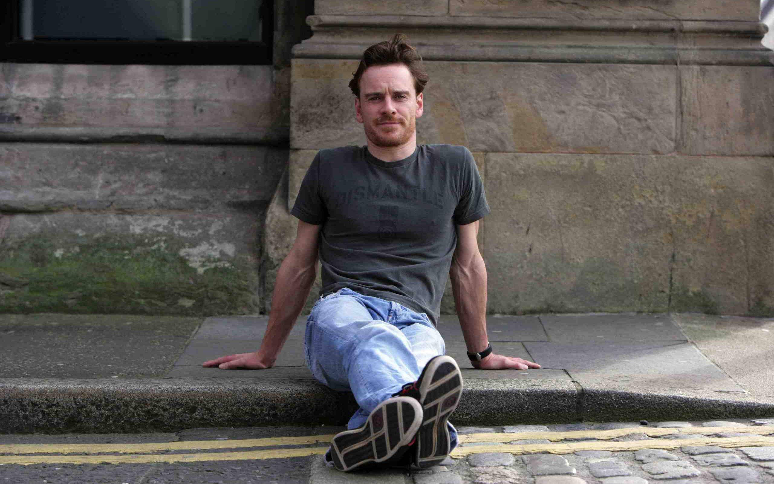 Michael Fassbender, stone step, weathered building facade, 2K Desktop Wallpaper