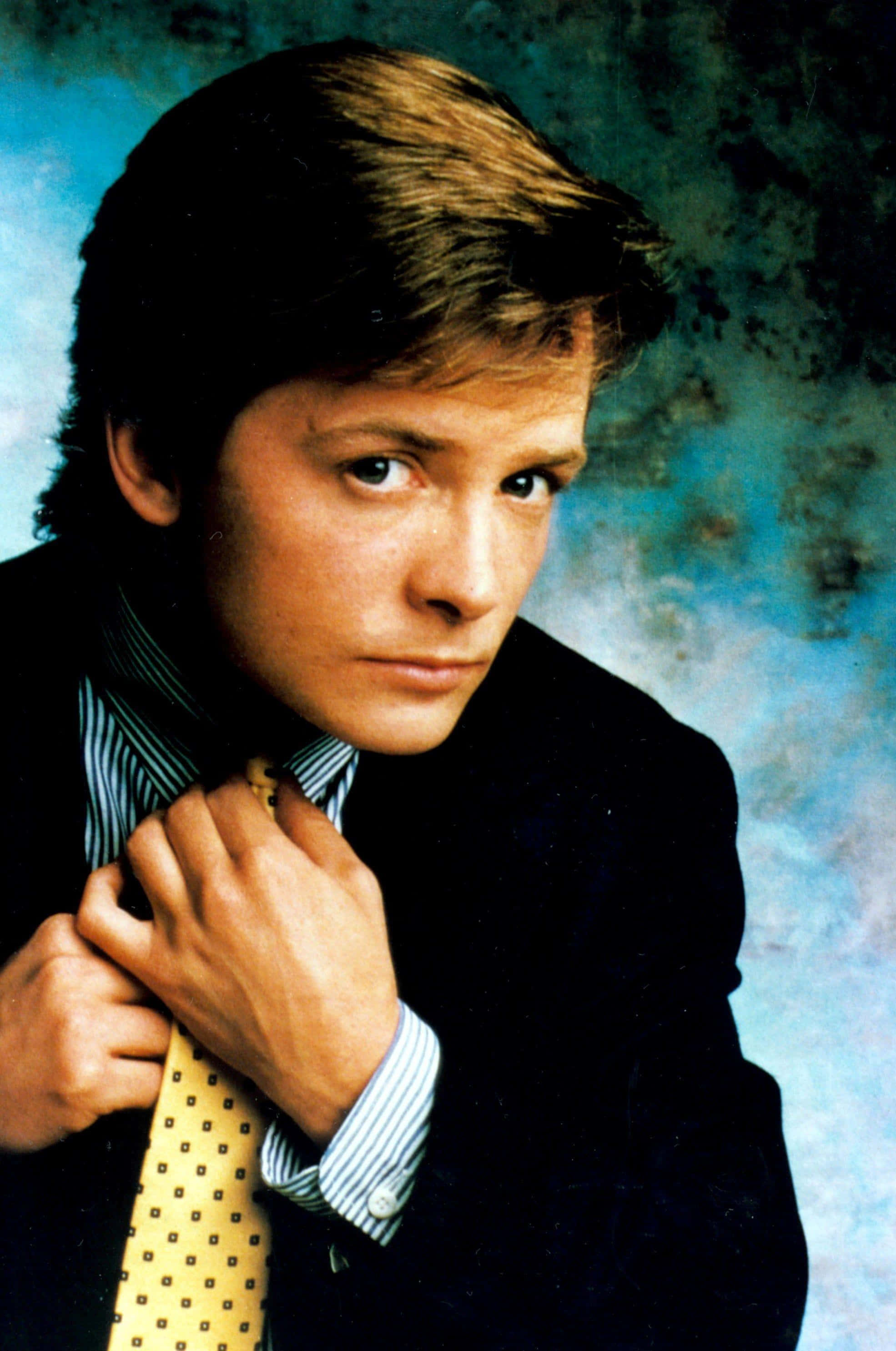 Michael J Fox, dark suit, yellow polka dot tie, 2K Phone Wallpaper