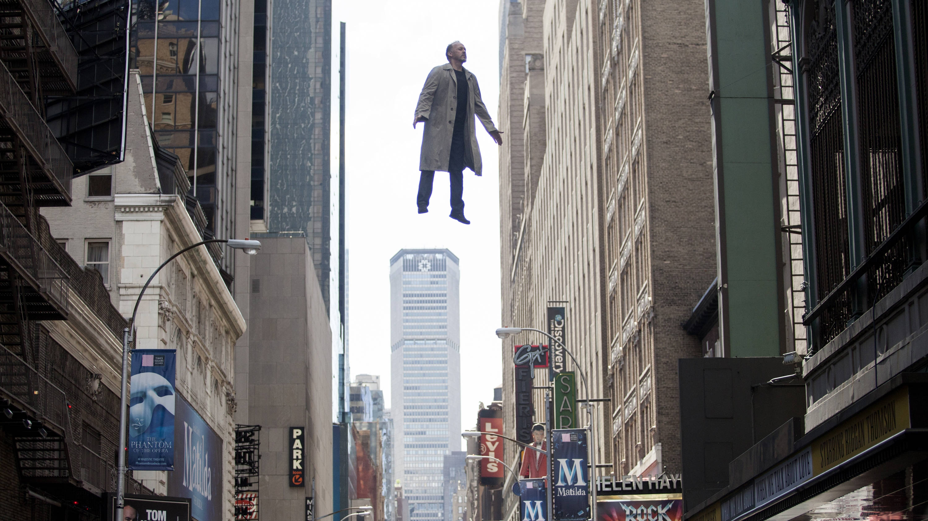 Michael Keaton, long coat, towering city buildings, 2K Desktop Wallpaper