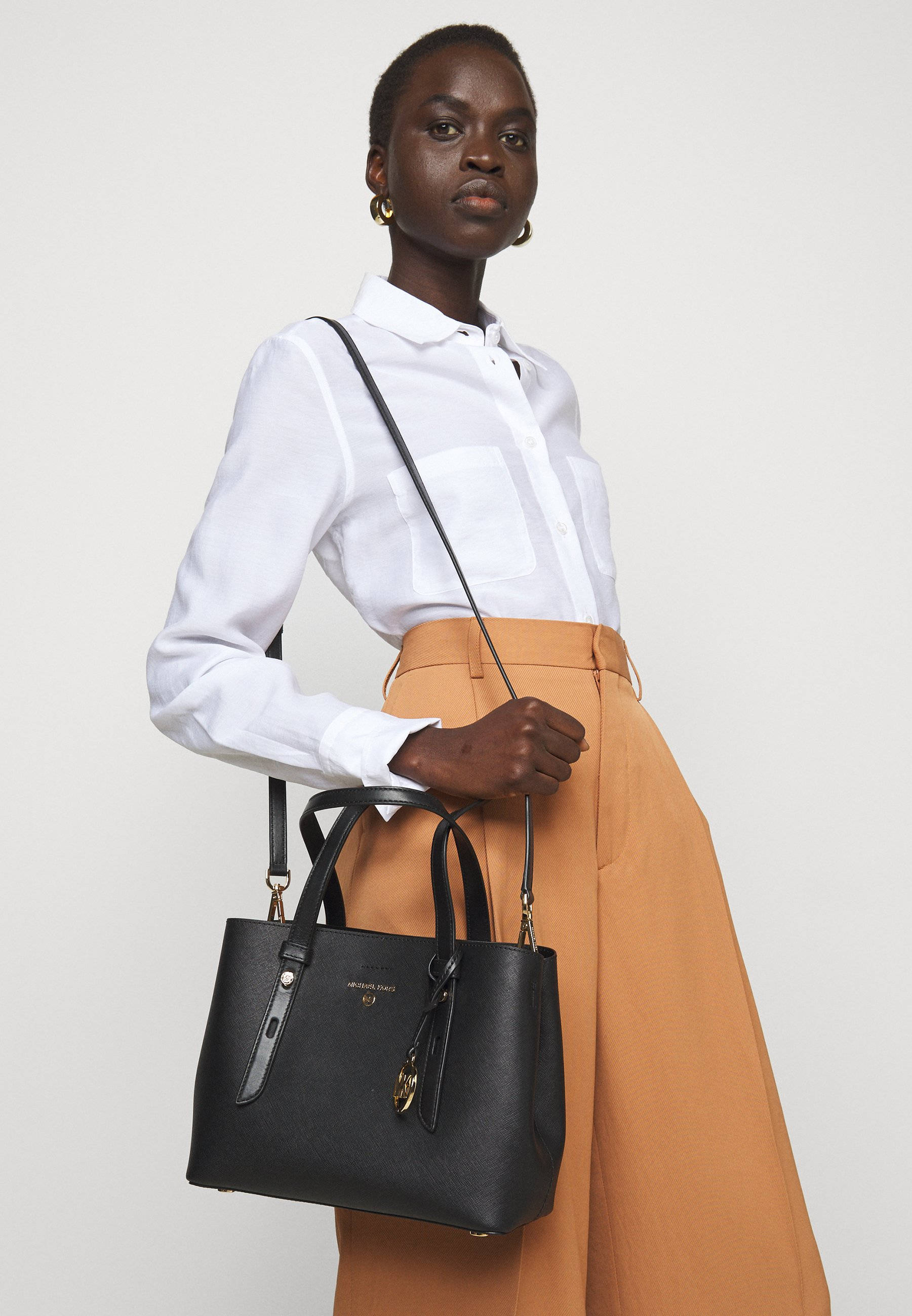 Michael Kors, black leather shoulder bag, crisp white shirt, 2K Phone Wallpaper