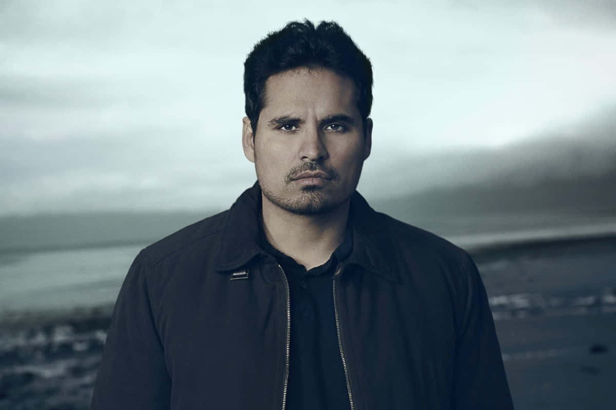 Michael Peña, dark jacket, misty coastal backdrop, SD Desktop Wallpaper