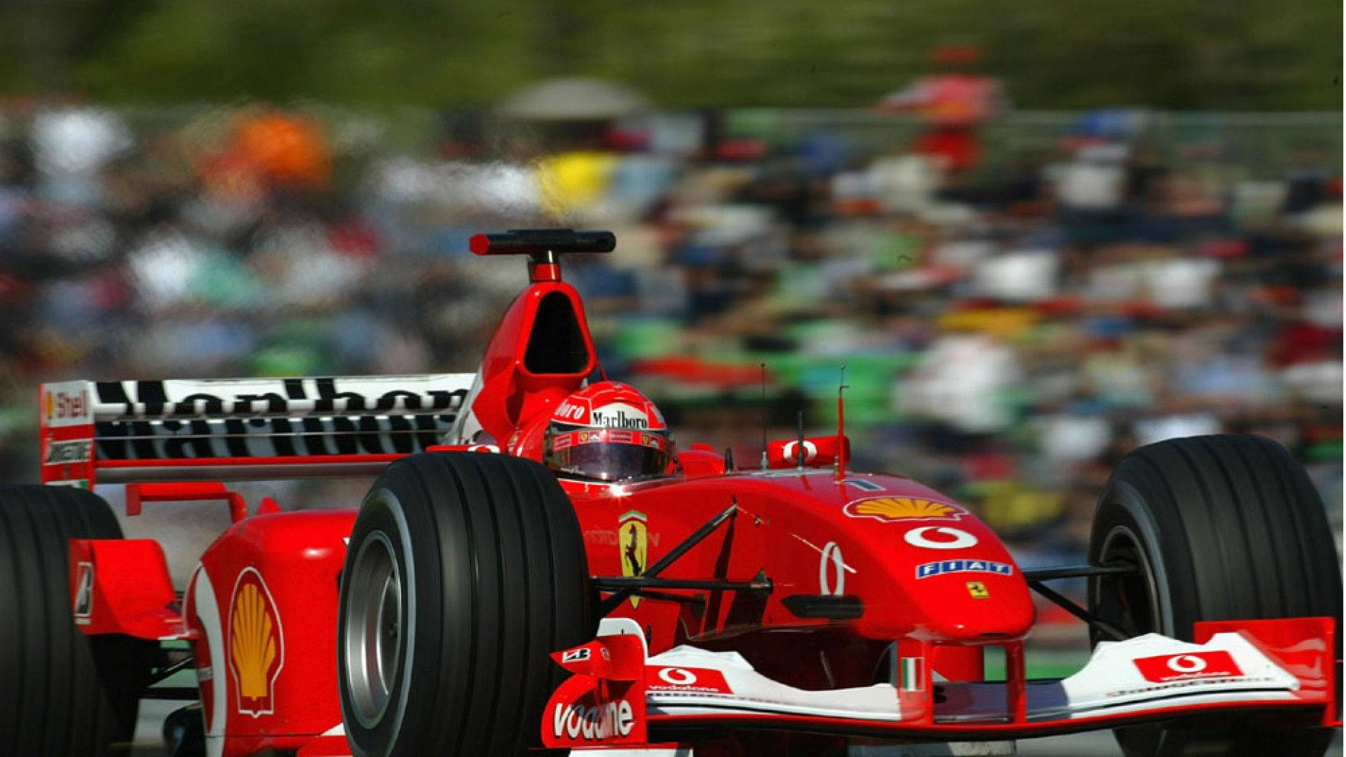 red Ferrari Formula 1 car, blurred spectators, speeds past, Full HD Desktop Wallpaper