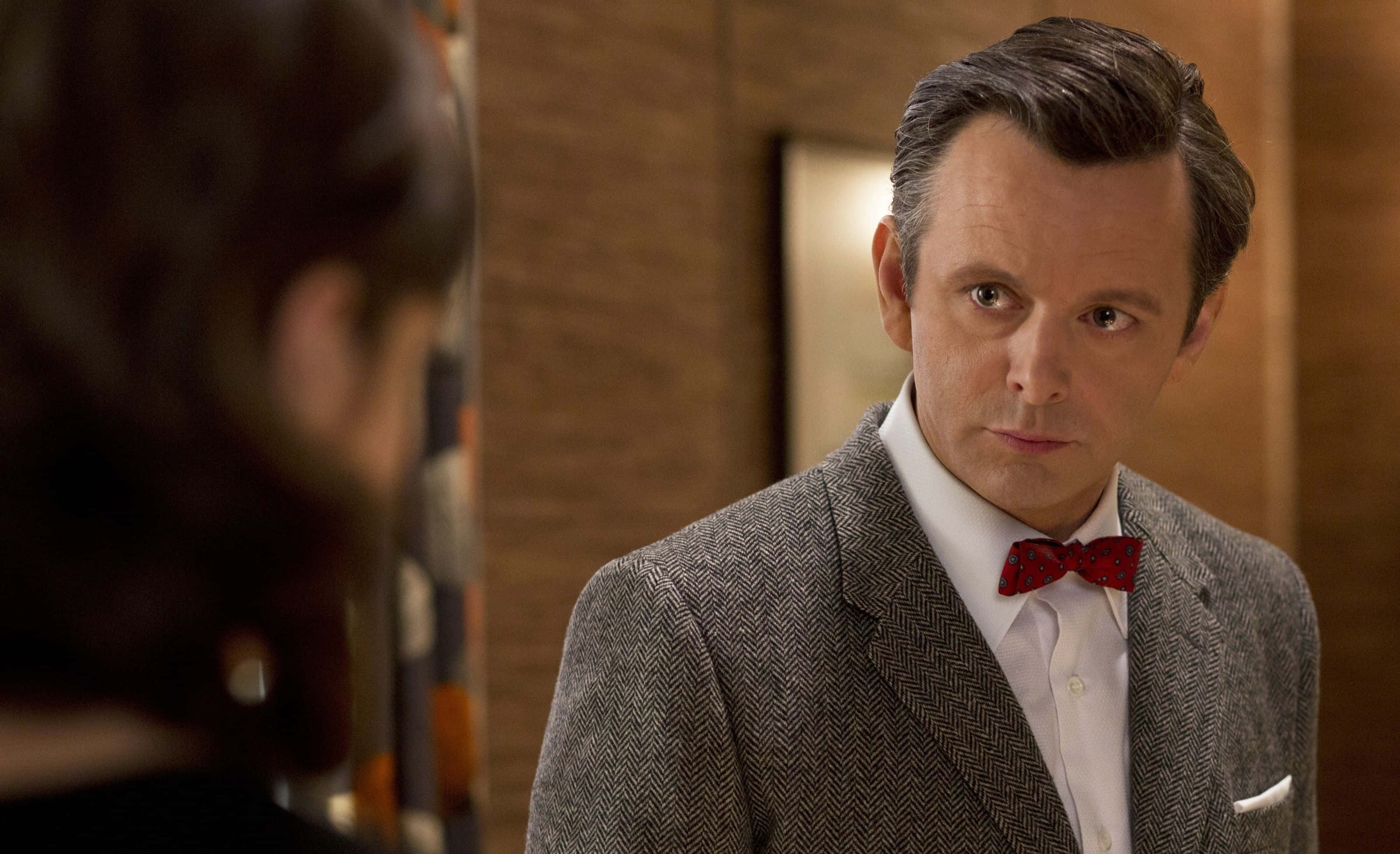 Michael Sheen, grey herringbone suit, red bow tie, 2K Desktop Wallpaper