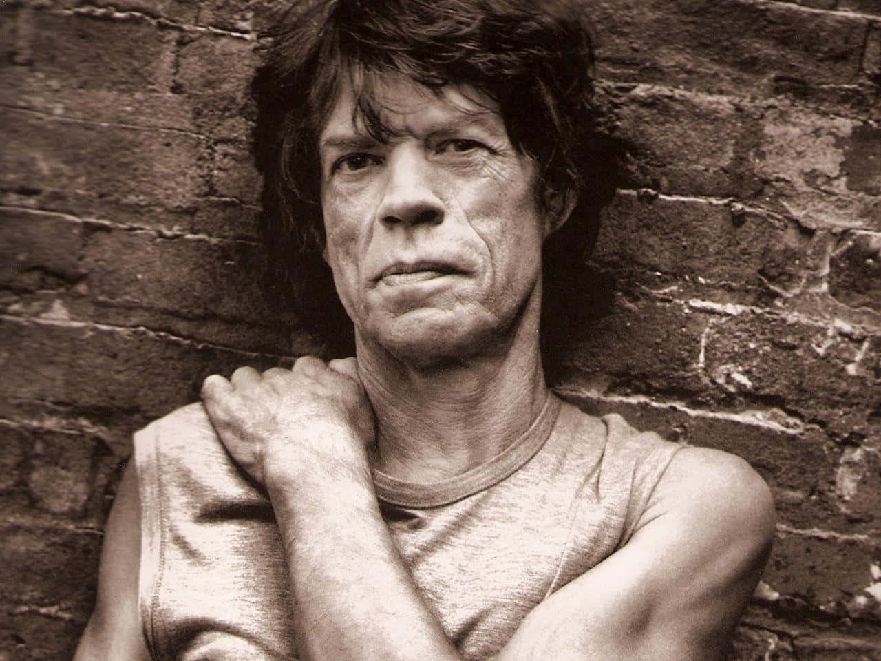 Mick Jagger, tousled hair, rough brick wall, HD Desktop Wallpaper