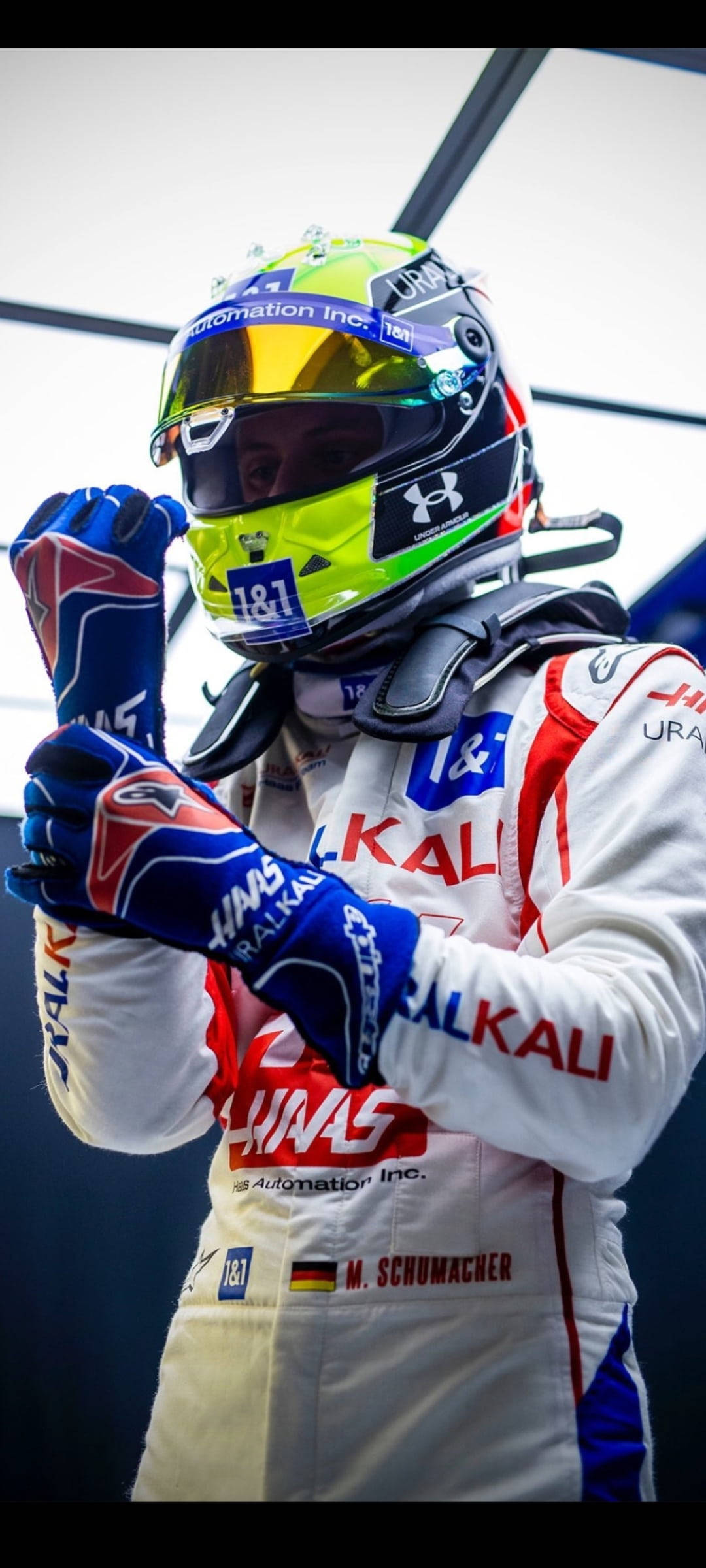 Mick Schumacher, vibrant yellow and blue helmet, white racing suit, Full HD Phone Wallpaper
