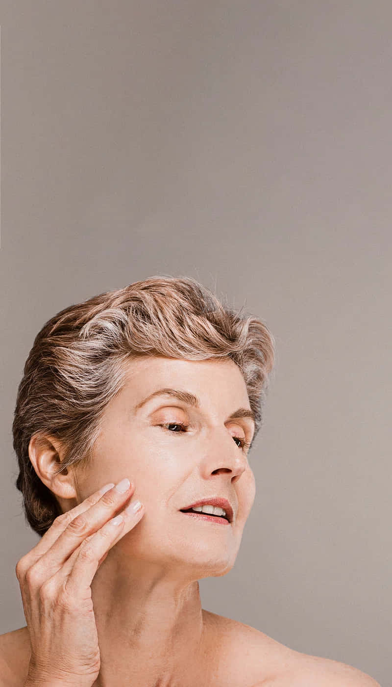 middle aged woman, short gray hair, plain gray background, HD Phone Wallpaper