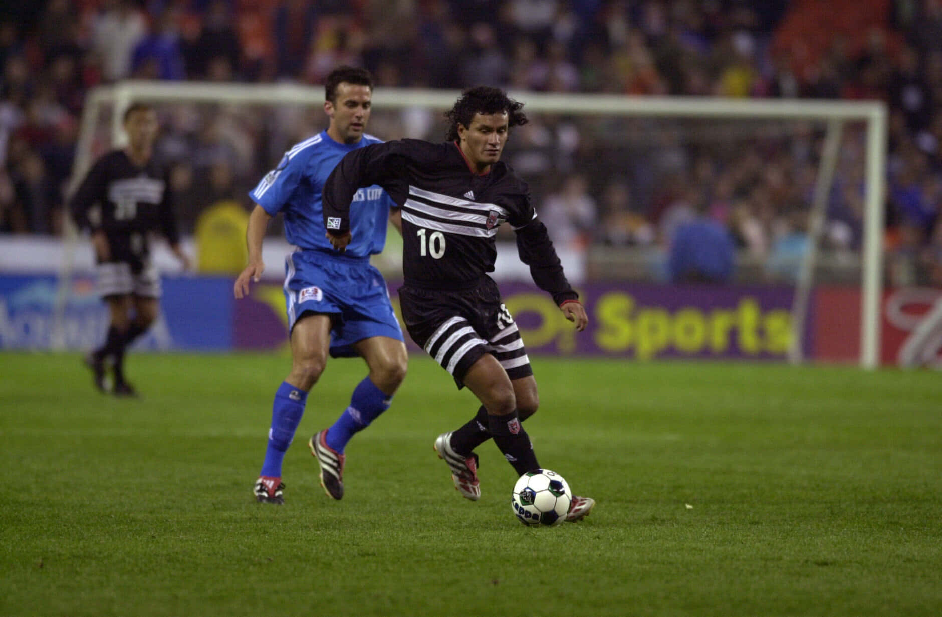 black jersey number 10, blue-uniformed opponent, vibrant green field, HD Desktop Wallpaper