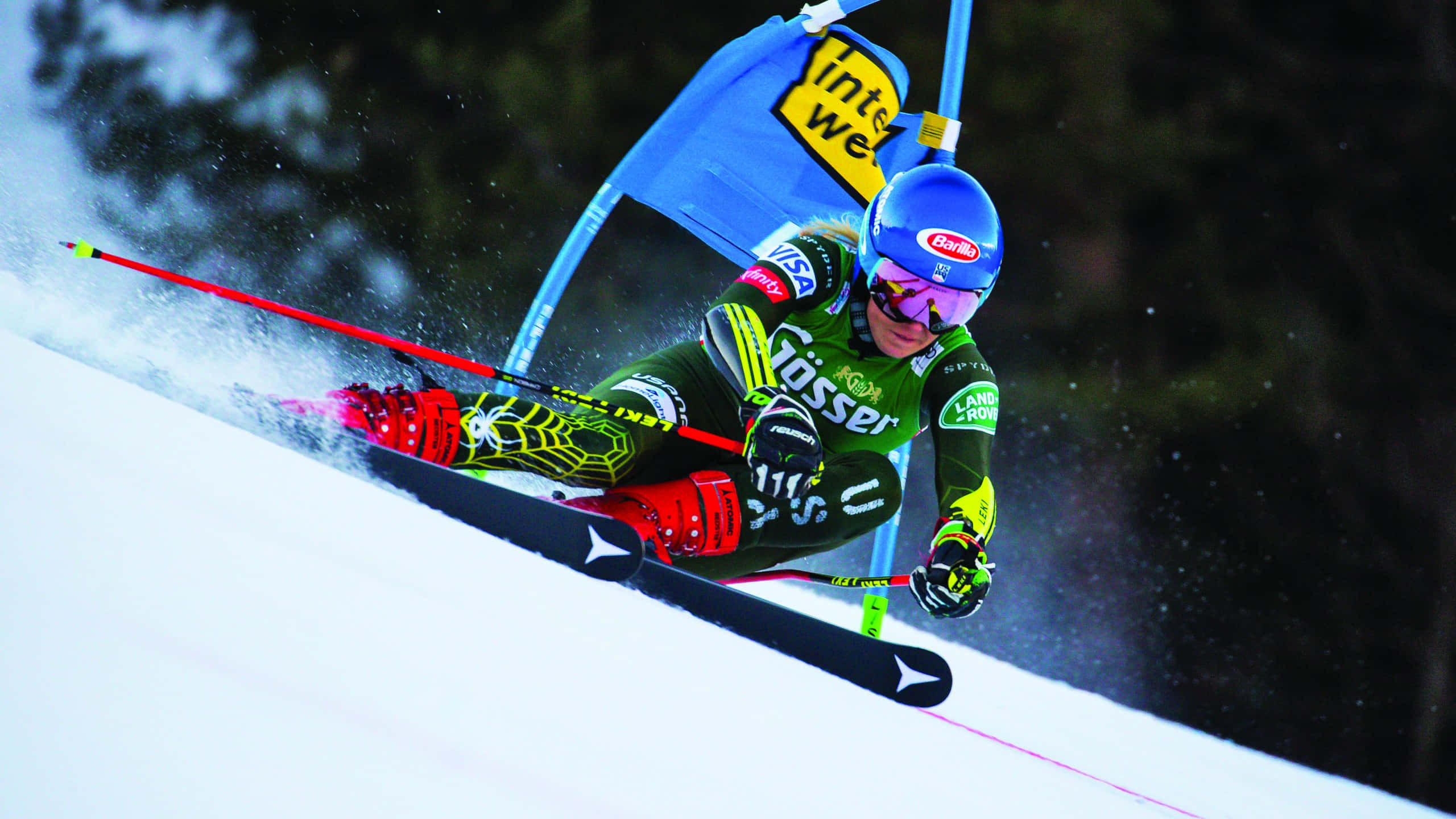 Mikaela Shiffrin, green and red gear, snowy slope, 2K Desktop Wallpaper