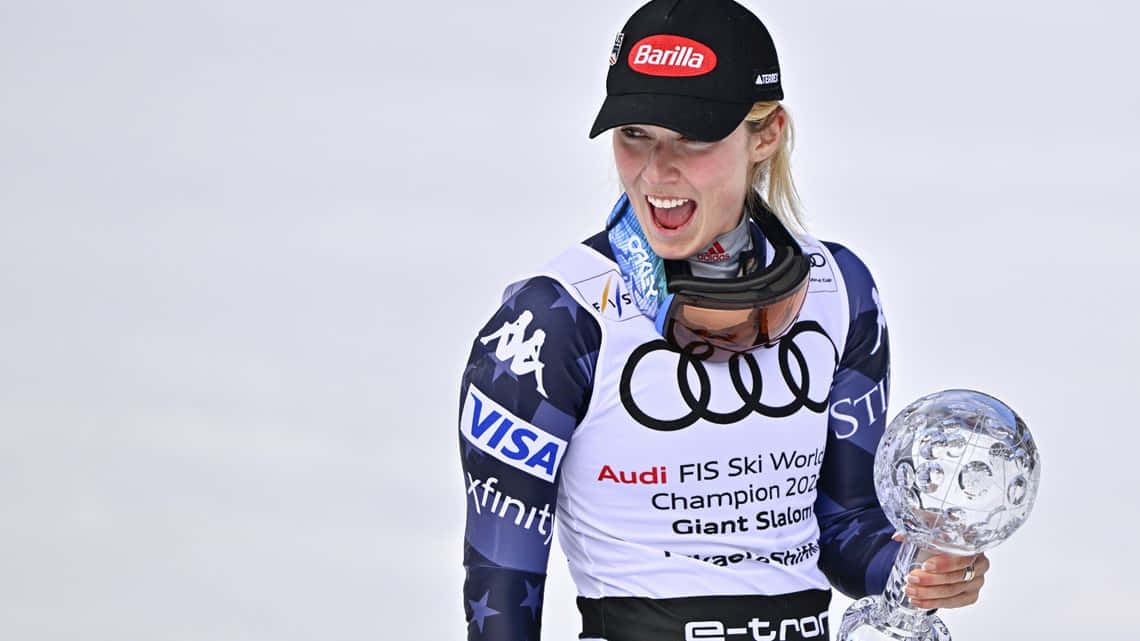 Mikaela Shiffrin, crystal globe trophy, snowy backdrop, SD Desktop Wallpaper