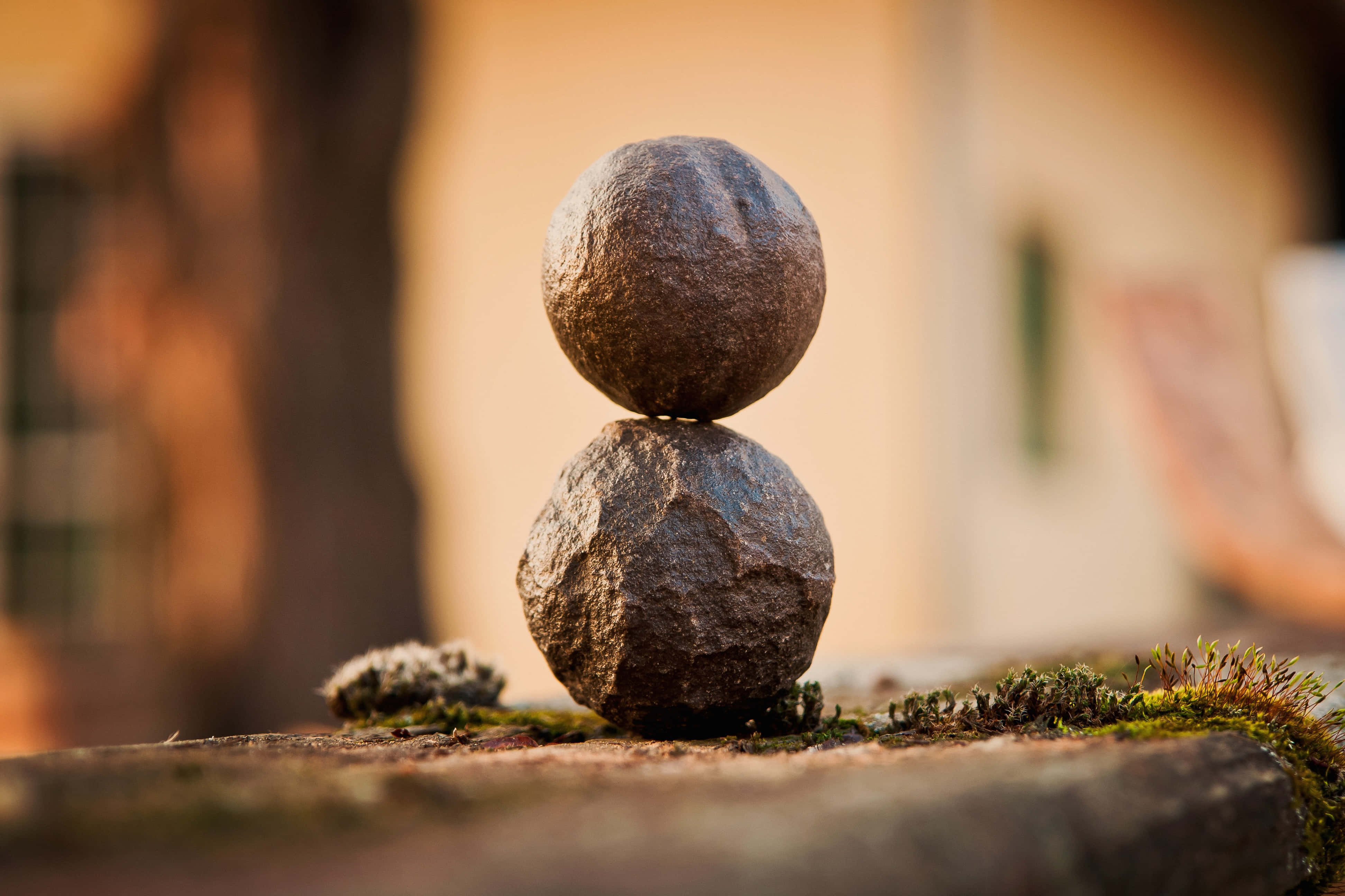 Balanced Stones Of Mindfulness, mossy surface, warm golden light, 4K Desktop Wallpaper