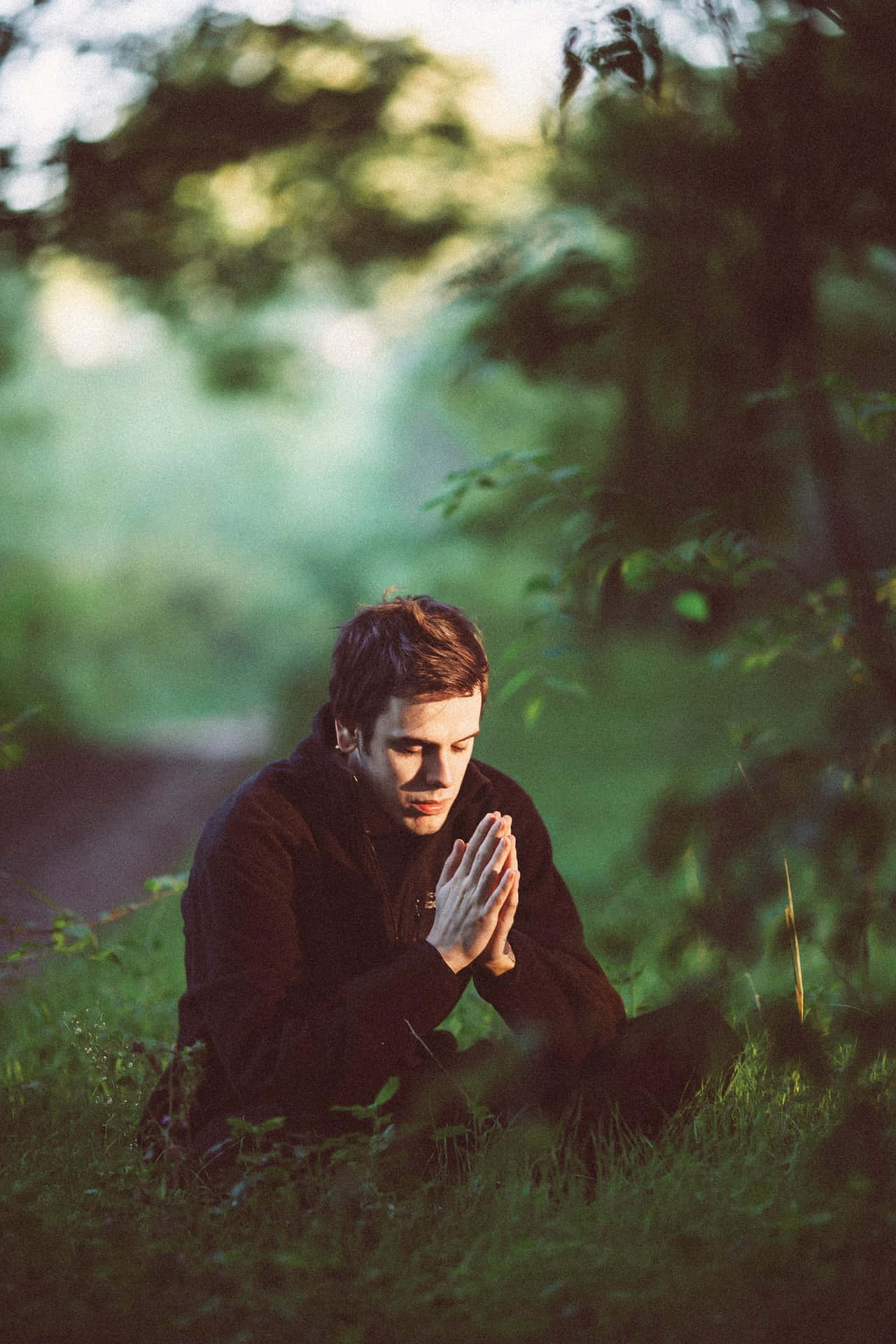 young man, grass, hands clasped in prayer, Full HD Phone Wallpaper