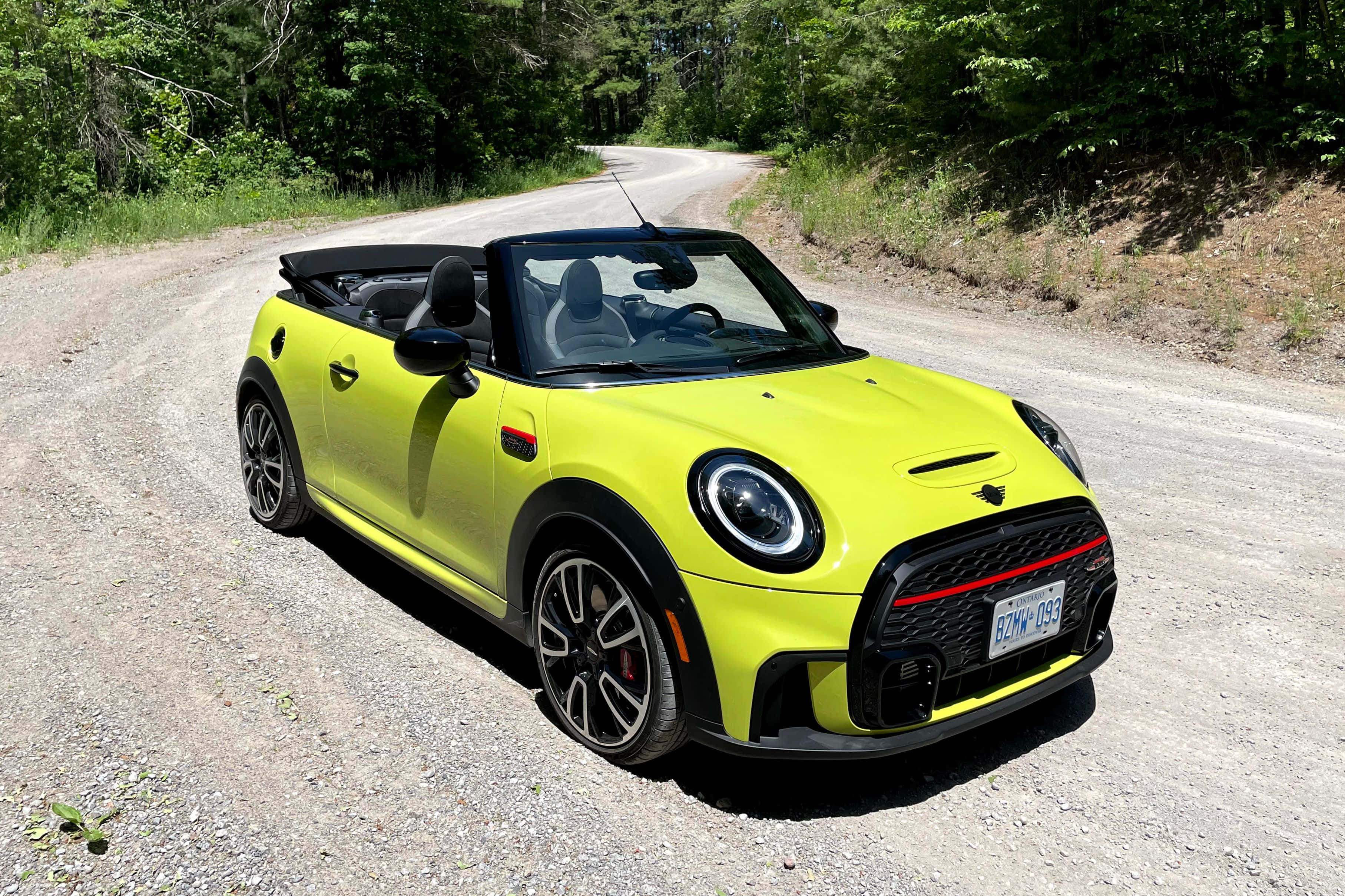 MINI Cooper convertible, vibrant yellow, sunlit gravel road, 2K Desktop Wallpaper