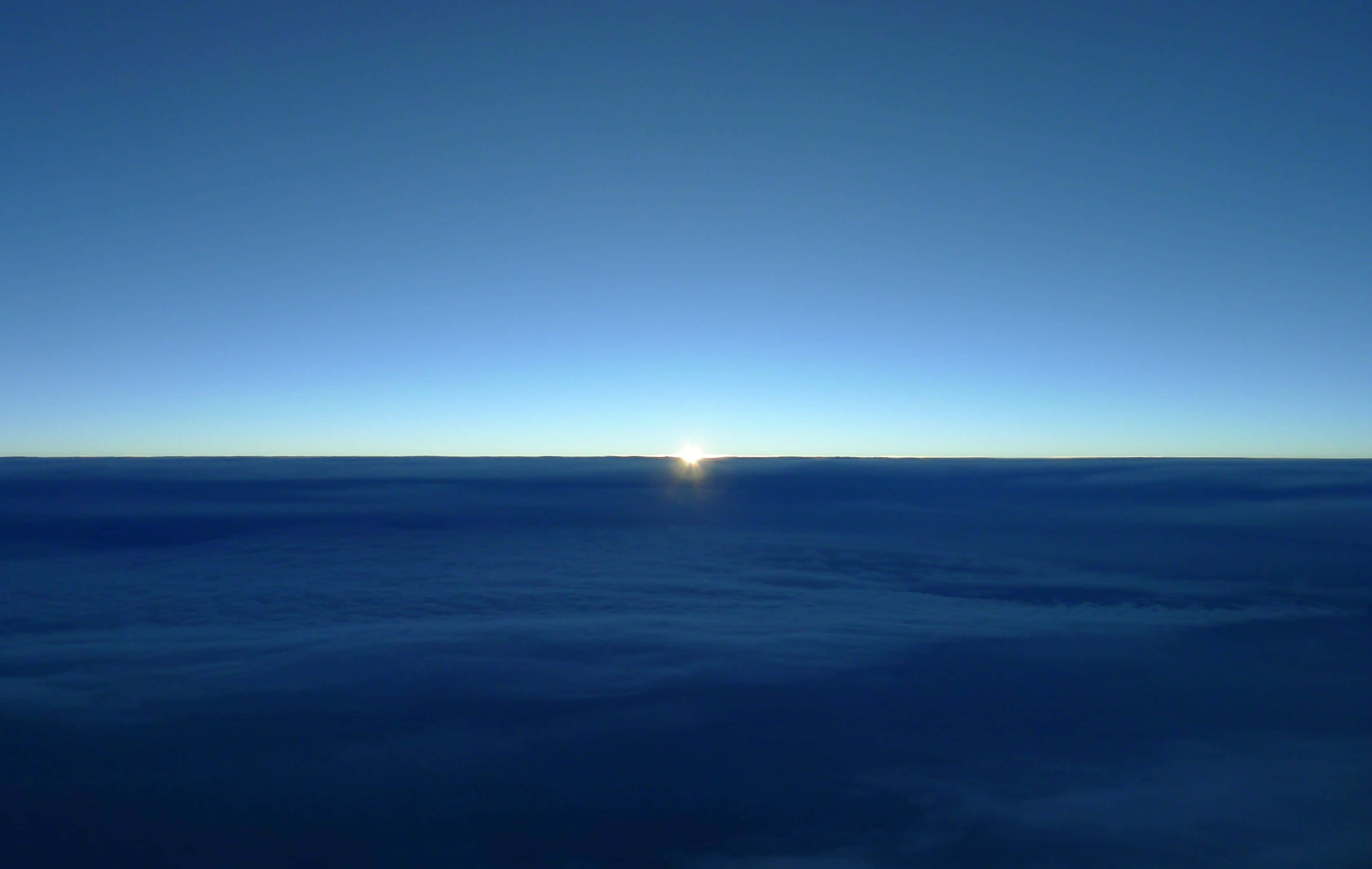 minimalist ocean, endless sea of clouds, soft blue glow, 2K Desktop Wallpaper