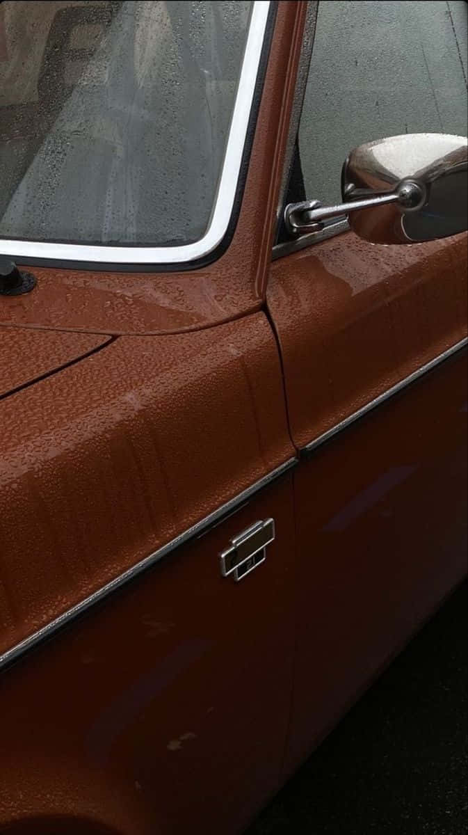 vintage rusty orange car door, raindrops glistening, chrome trim, SD Phone Wallpaper