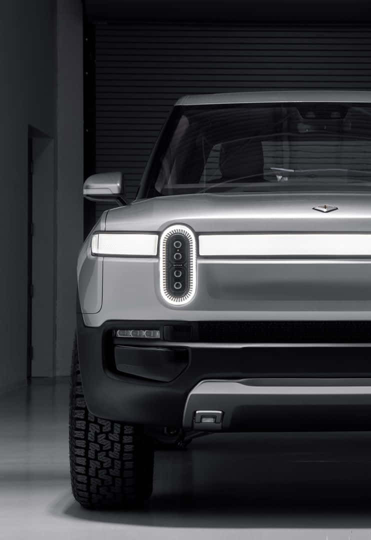 sleek silver futuristic SUV, glowing vertical headlights, minimalist industrial garage, SD Phone Wallpaper