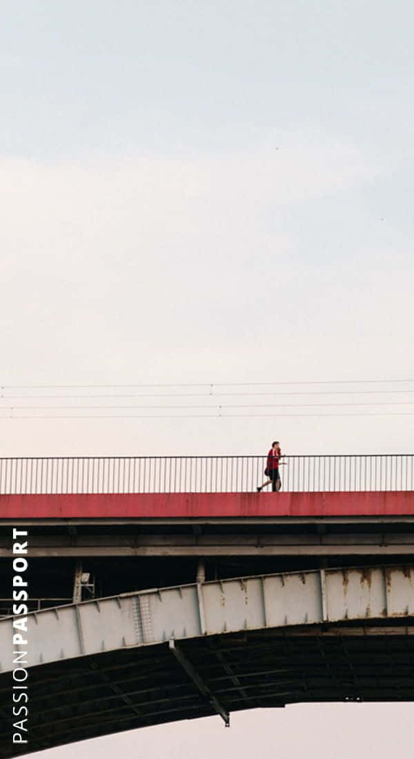 minimalist cityscape, lone runner in red, weathered steel bridge, SD Phone Wallpaper