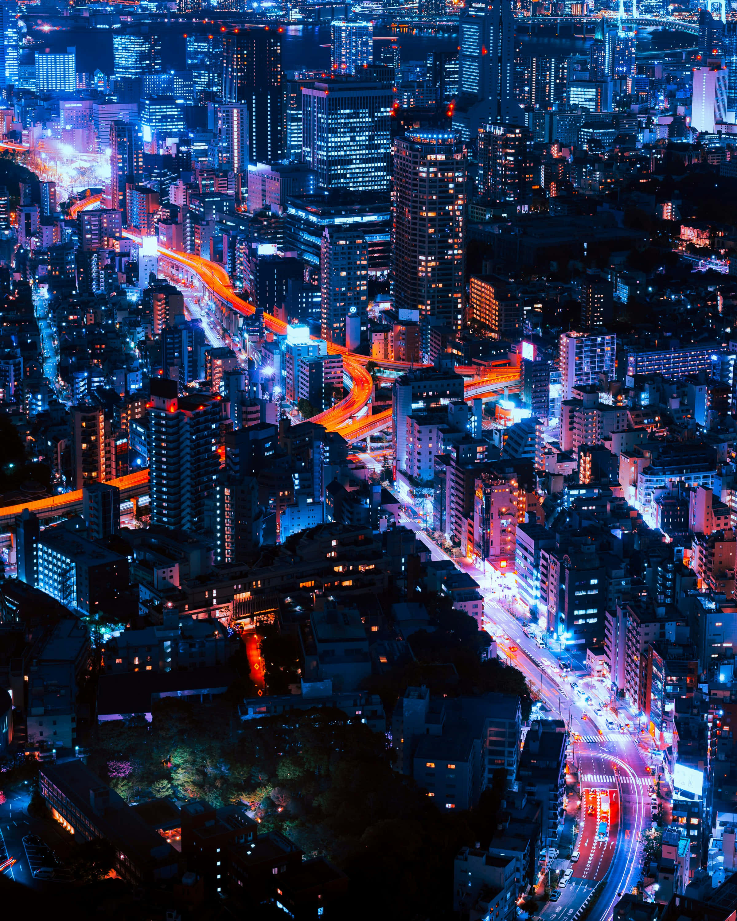neon-lit cityscape, glowing blue and orange light trails, traffic, 2K Phone Wallpaper