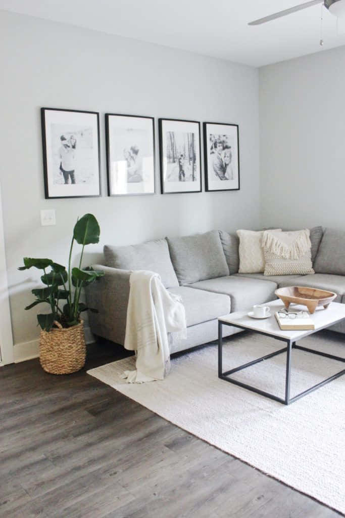 minimalist living room, gray sectional sofa, black-framed wall art, SD Phone Wallpaper
