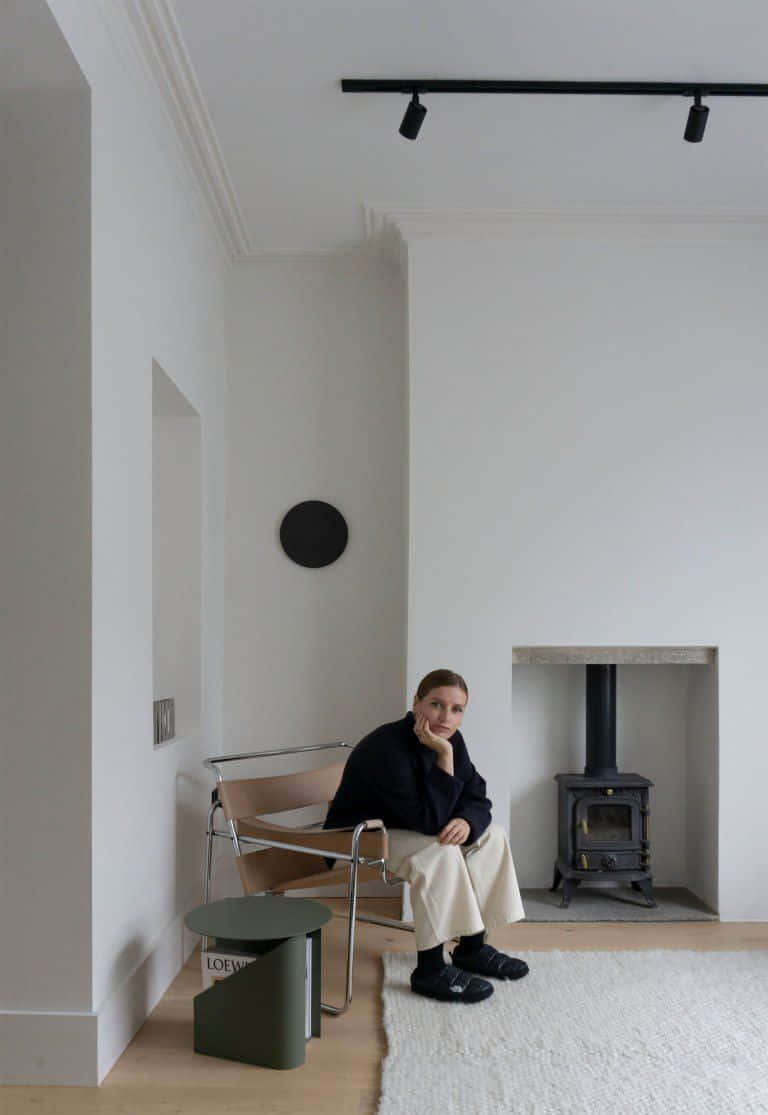minimalist white room, wood-burning stove, modern chair, SD Phone Wallpaper