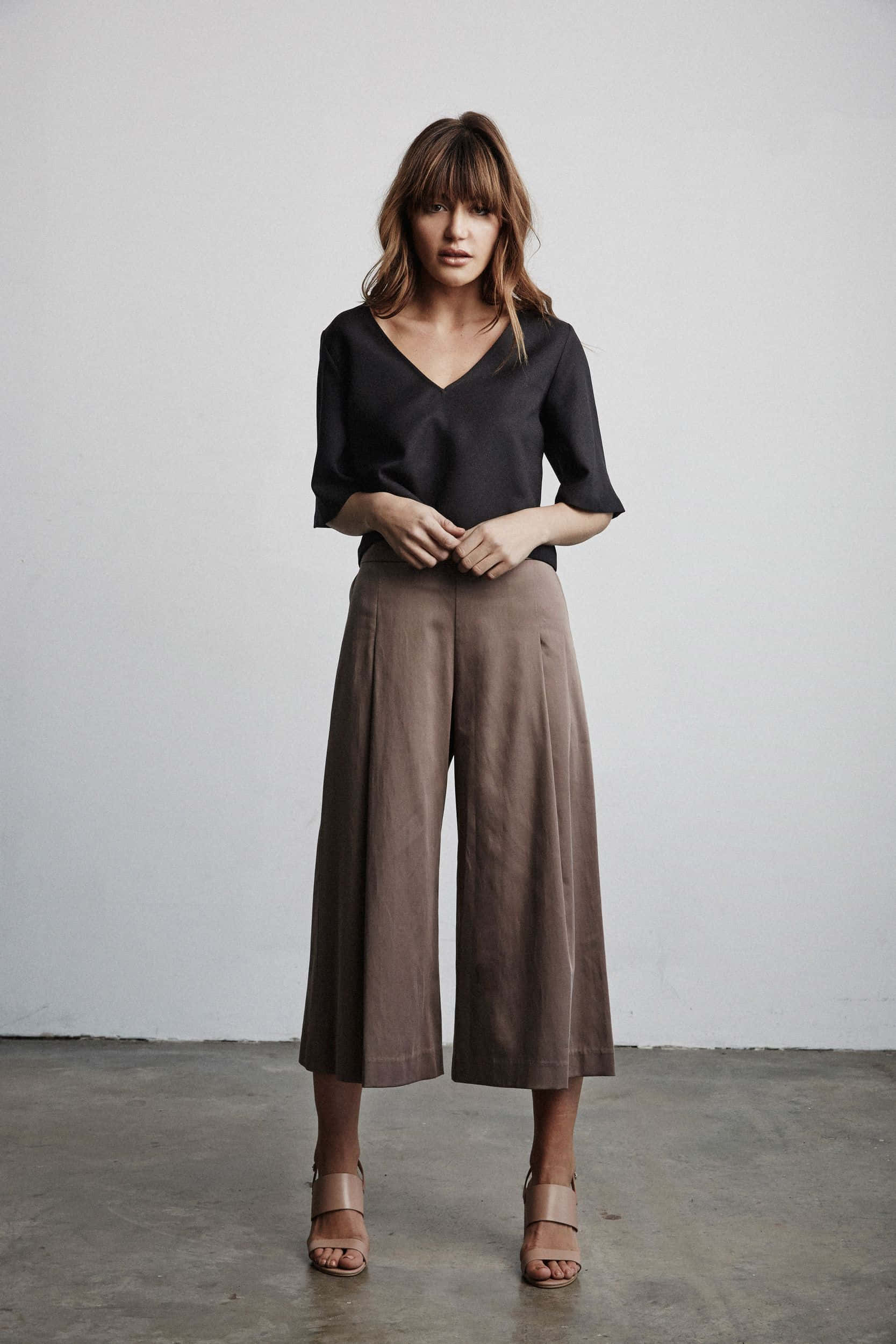 black top, brown wide-leg pants, plain white wall, Full HD Phone Wallpaper