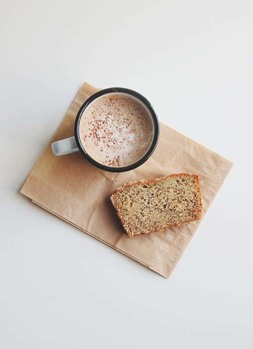 cinnamon dusted latte, slice of banana bread, brown paper napkin, SD Phone Wallpaper