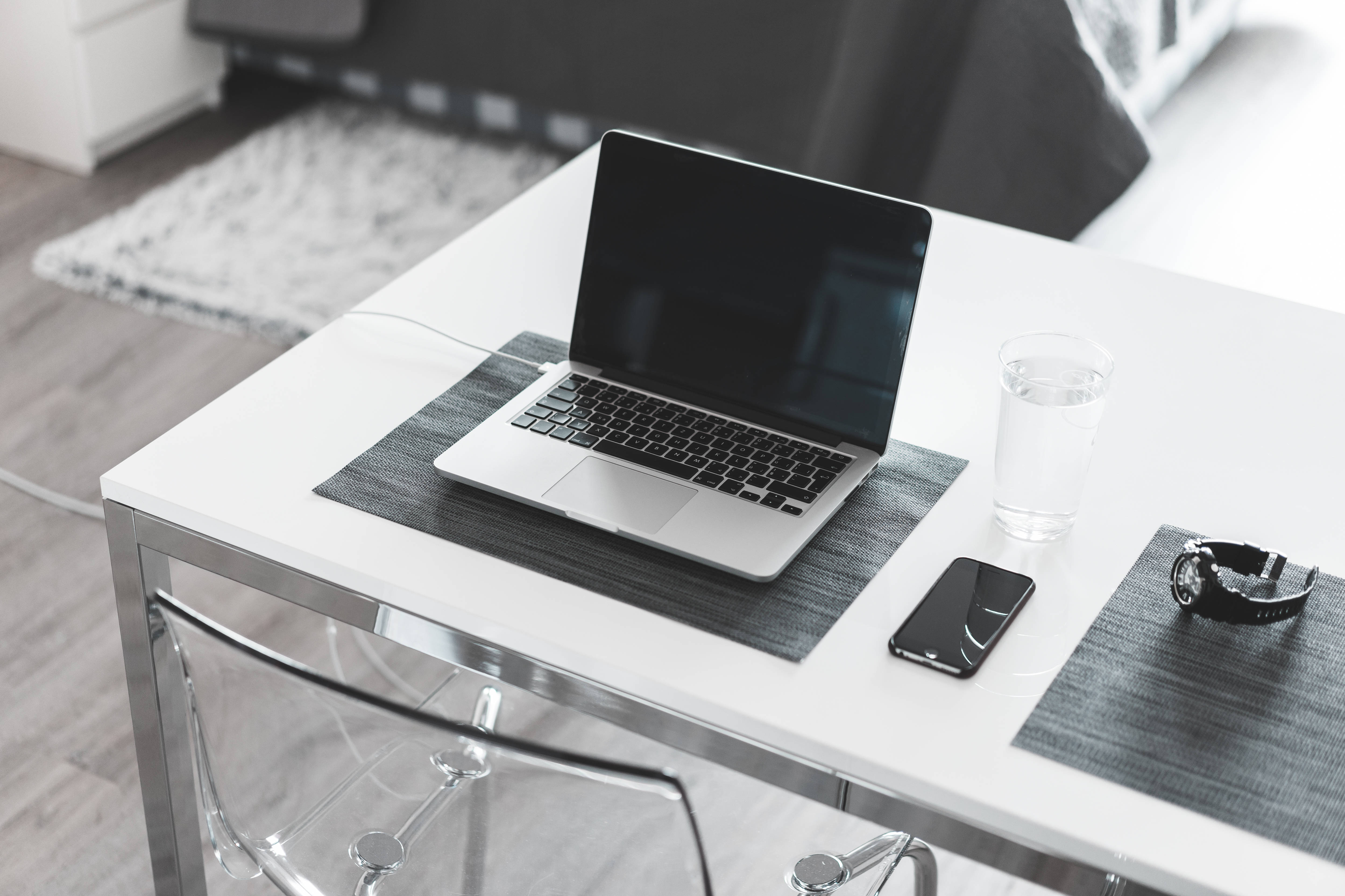 sleek silver laptop, white desk, glass of water, 4K Desktop Wallpaper