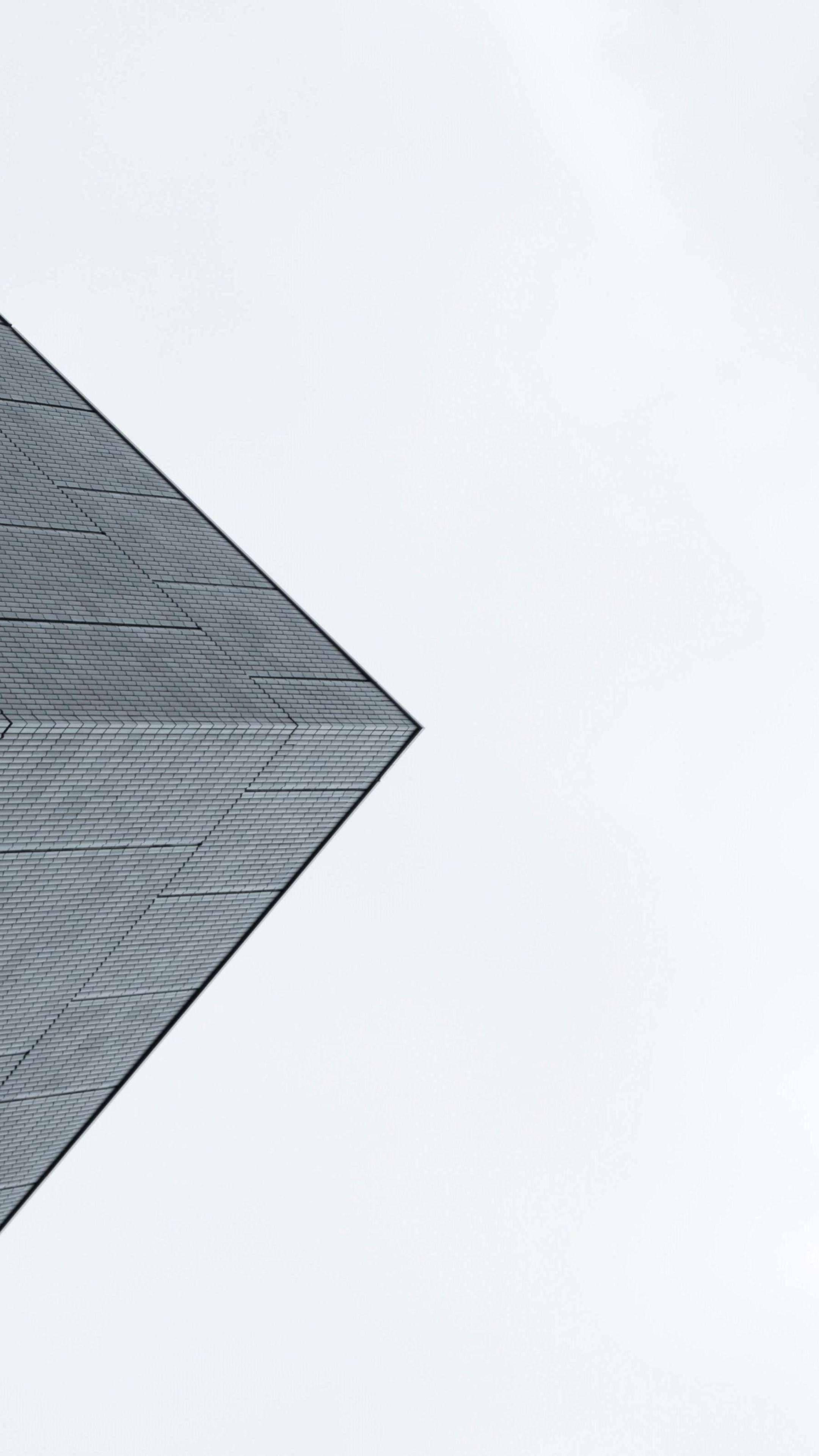 minimalist geometric rooftop corner, textured gray tiles, vast pale sky, 4K Phone Wallpaper