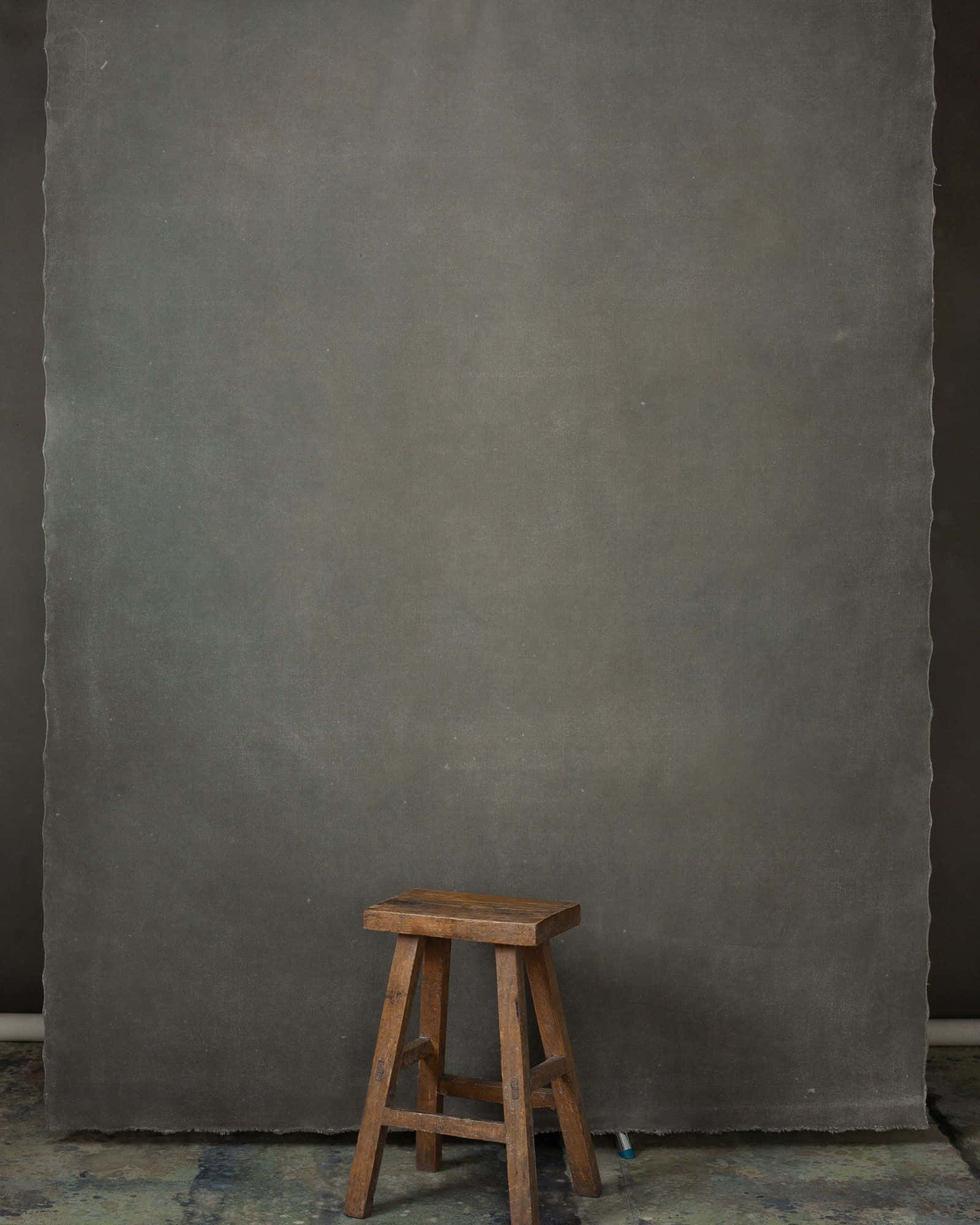 wooden stool, textured gray backdrop, dimly lit studio space, Full HD Phone Wallpaper