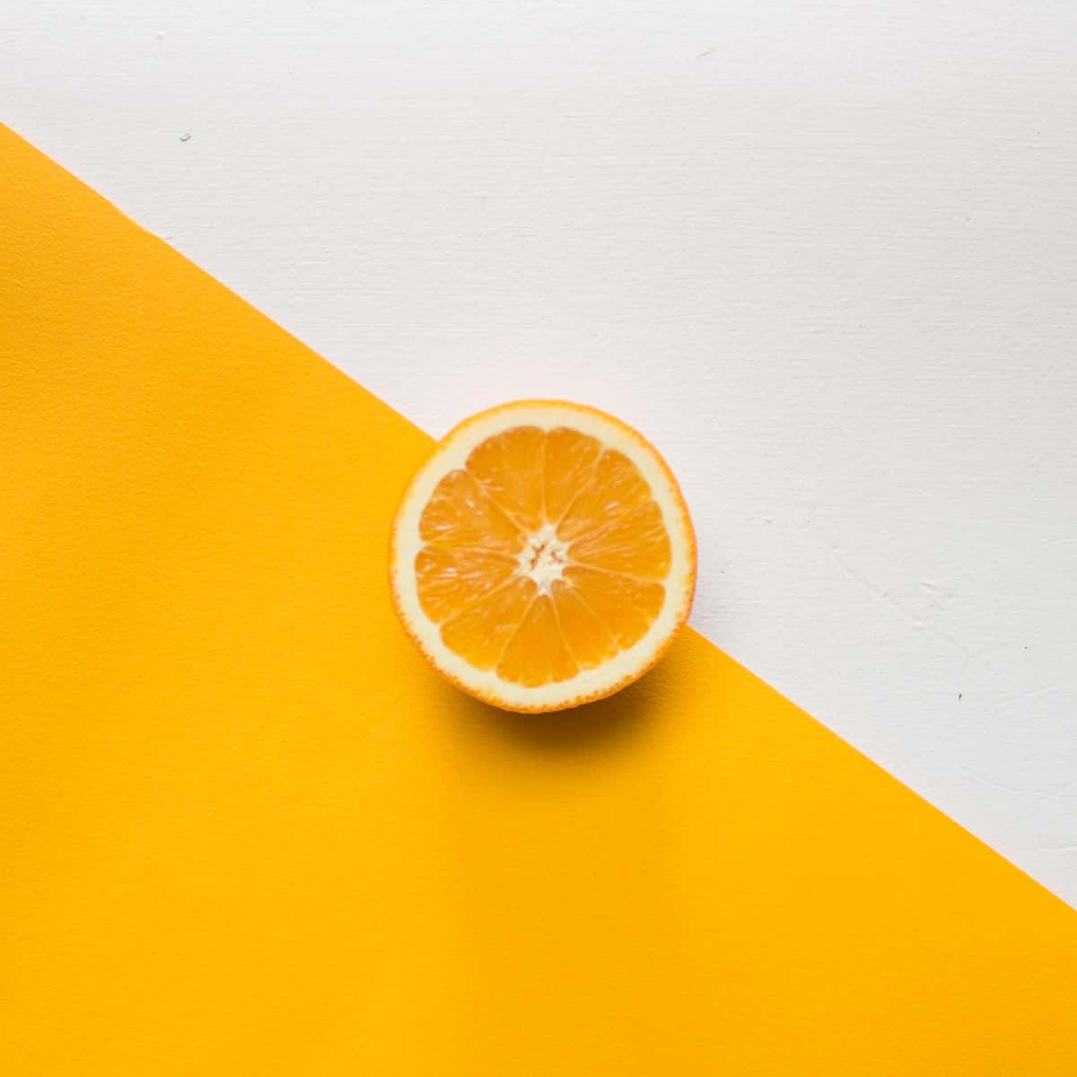 vibrant orange slice, bold yellow and white diagonal background, juicy segments, SD Desktop Wallpaper
