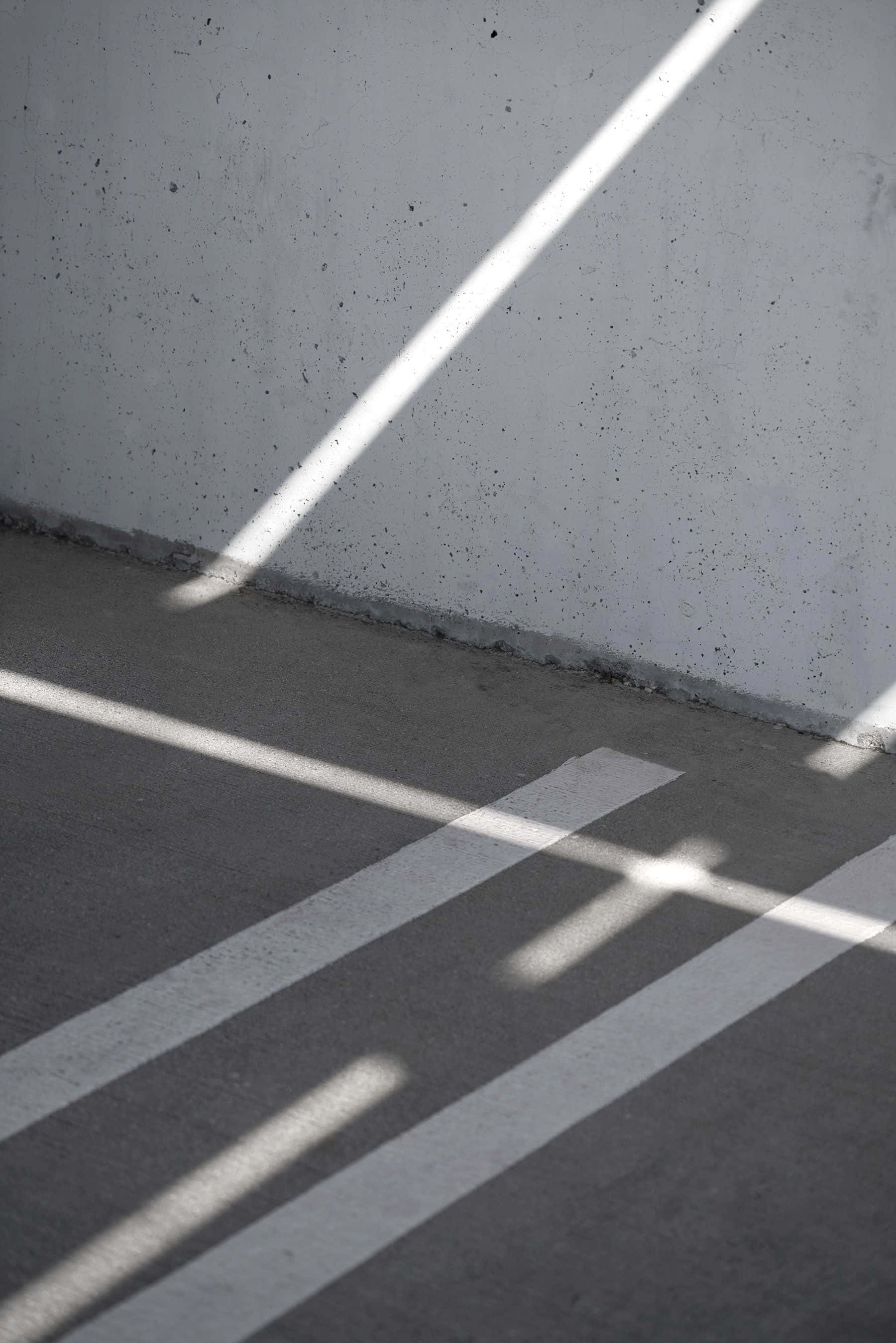 minimalist photography, diagonal beams of sunlight, concrete floor, 2K Phone Wallpaper