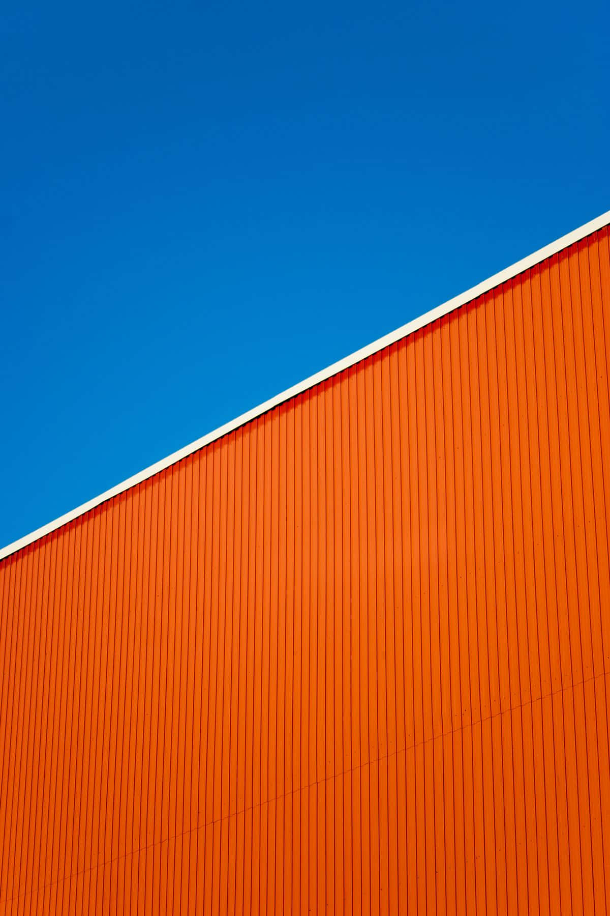 vibrant orange corrugated wall, clear blue sky, bold geometric composition, HD Phone Wallpaper