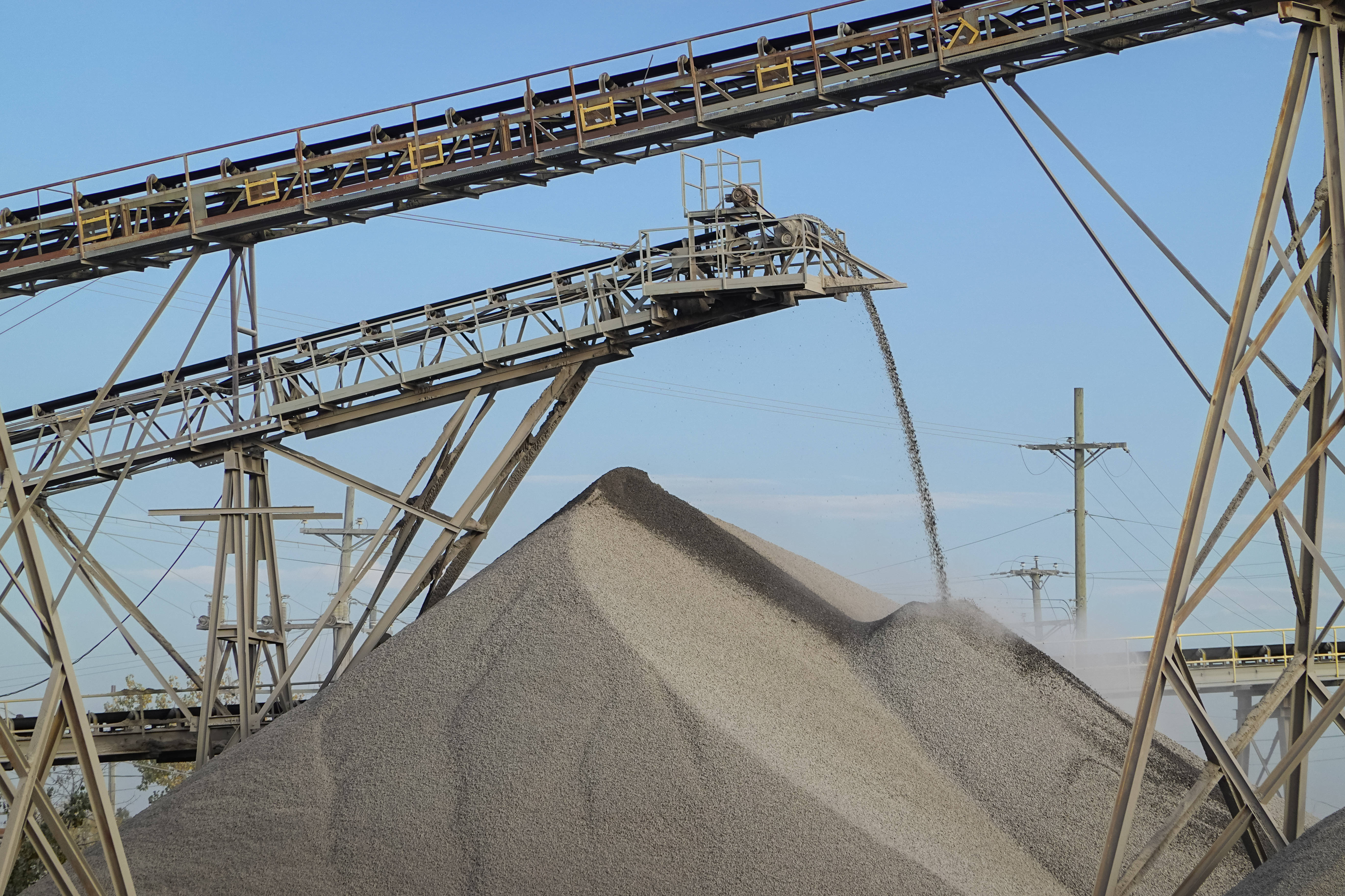 gravel, towering conveyor belt system, clear blue sky, 5K Desktop Wallpaper