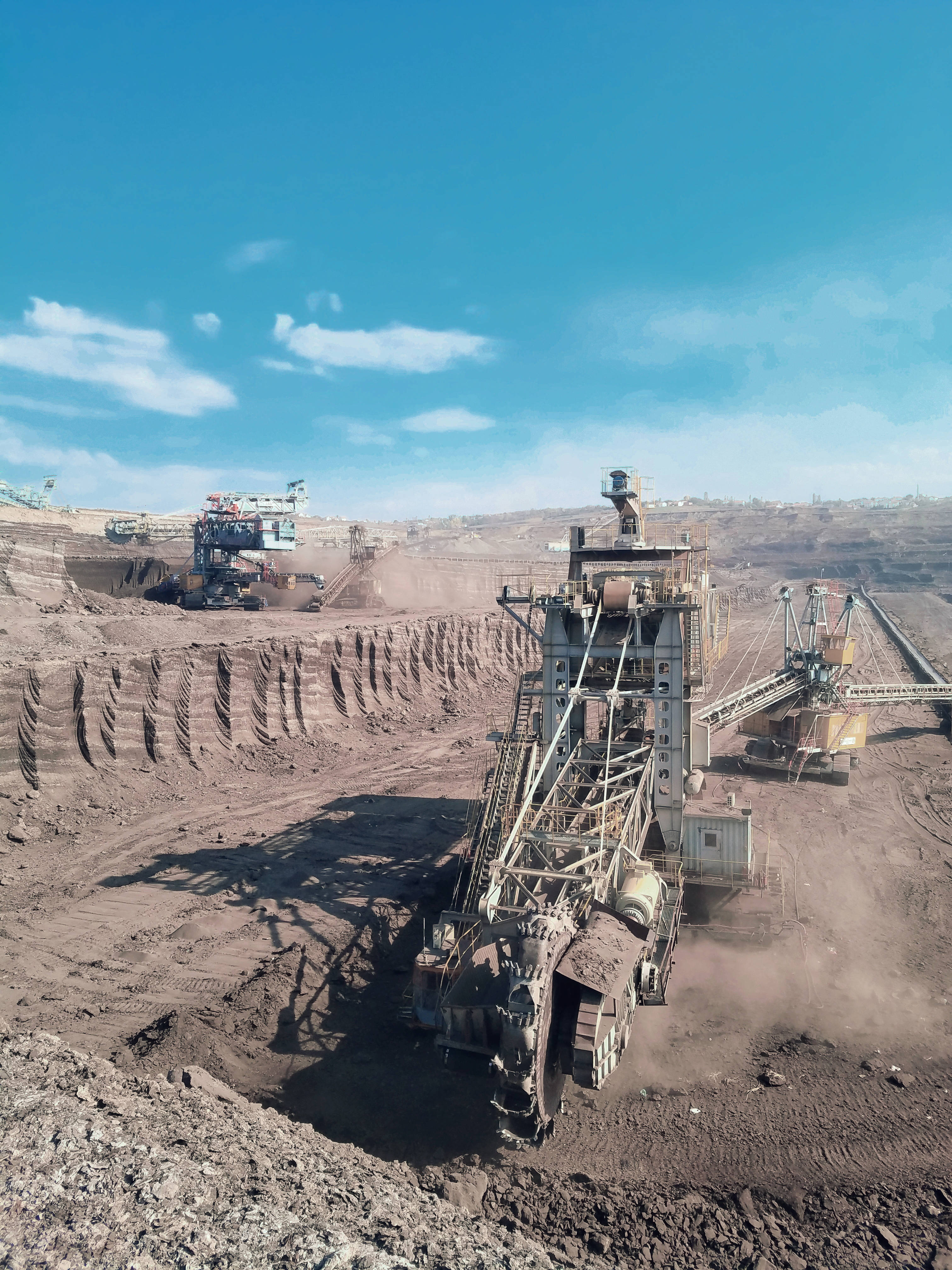 massive excavators, vast open-pit mine, clear blue sky, 4K Phone Wallpaper