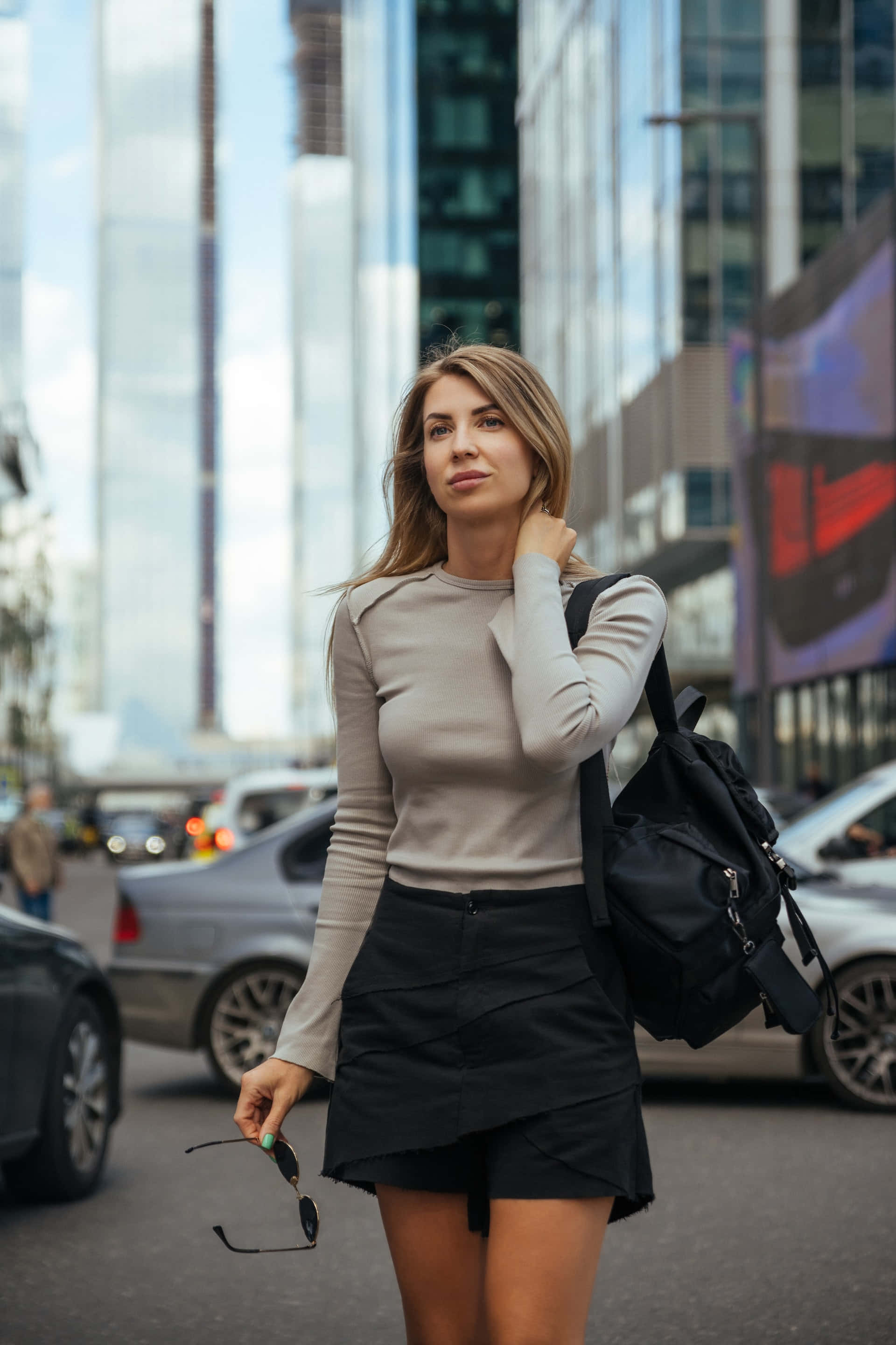 black office miniskirt, black backpack, bright urban street, 2K Phone Wallpaper