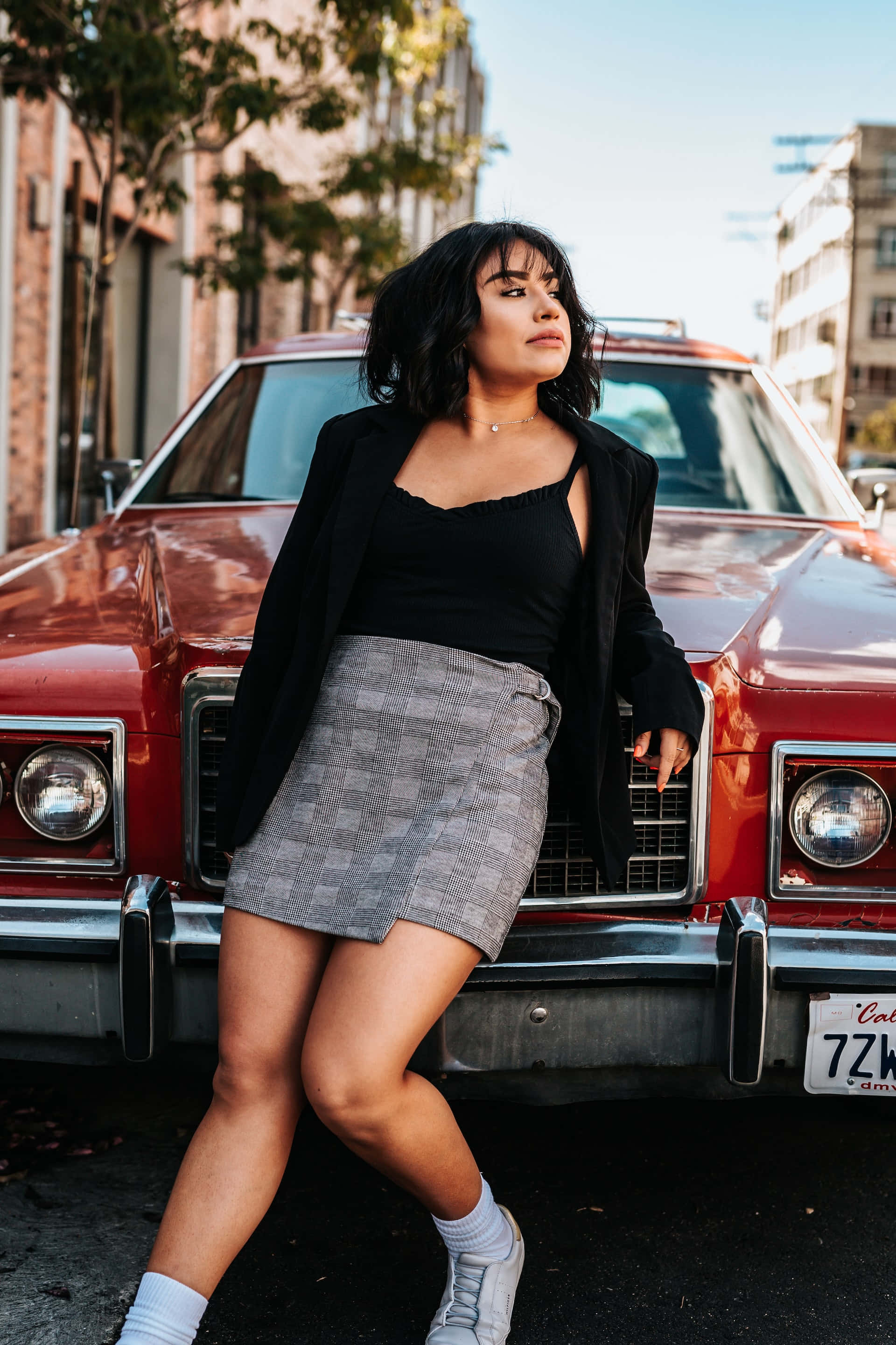 gray quilt miniskirt, vintage red car, sunlit city street, 2K Phone Wallpaper