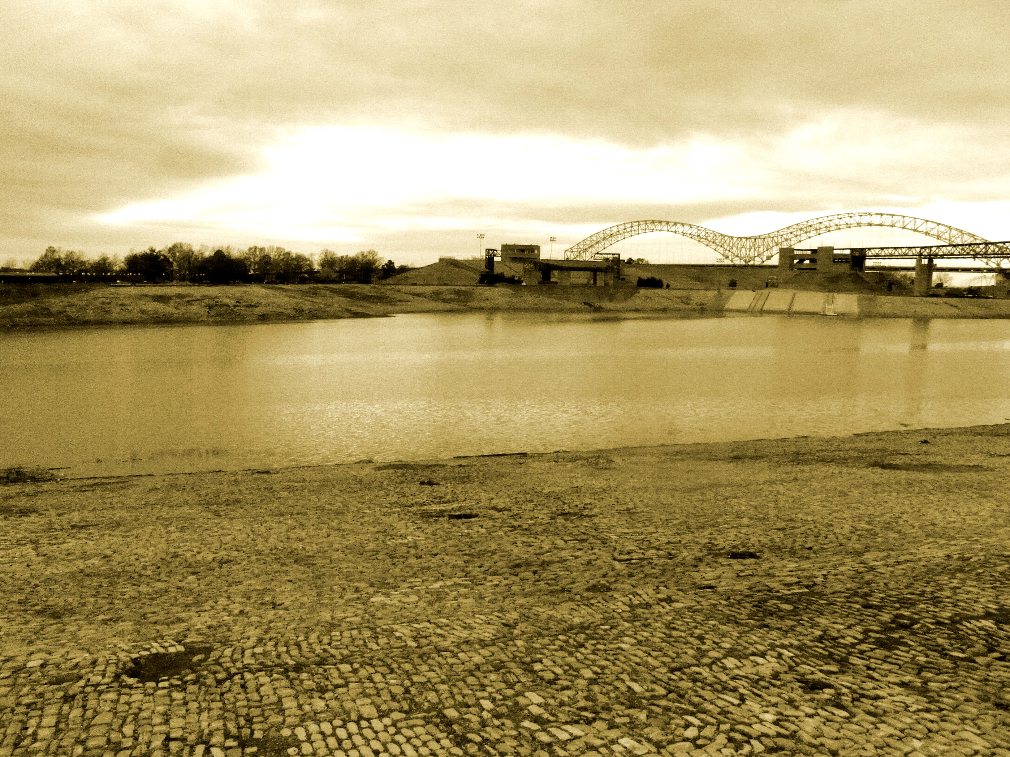 golden mississippi river, cobblestone foreground, large arched bridge, 2K Desktop Wallpaper