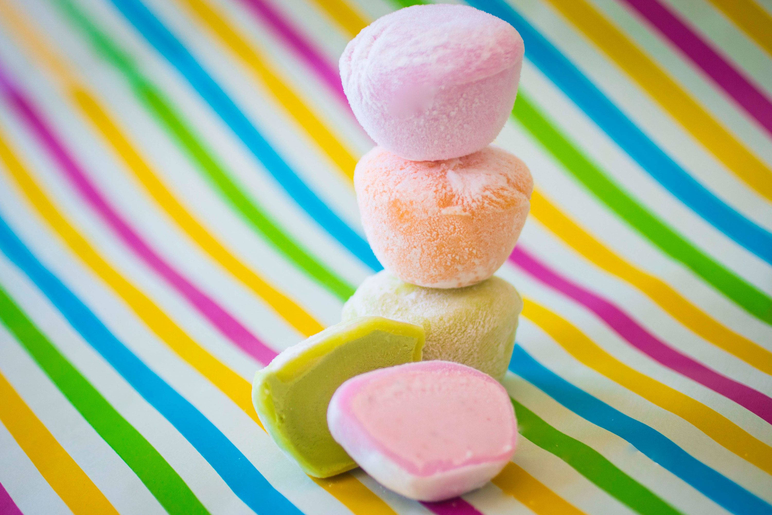 Colorful Mochi, pastel marshmallows, vibrant striped background, 2K Desktop Wallpaper