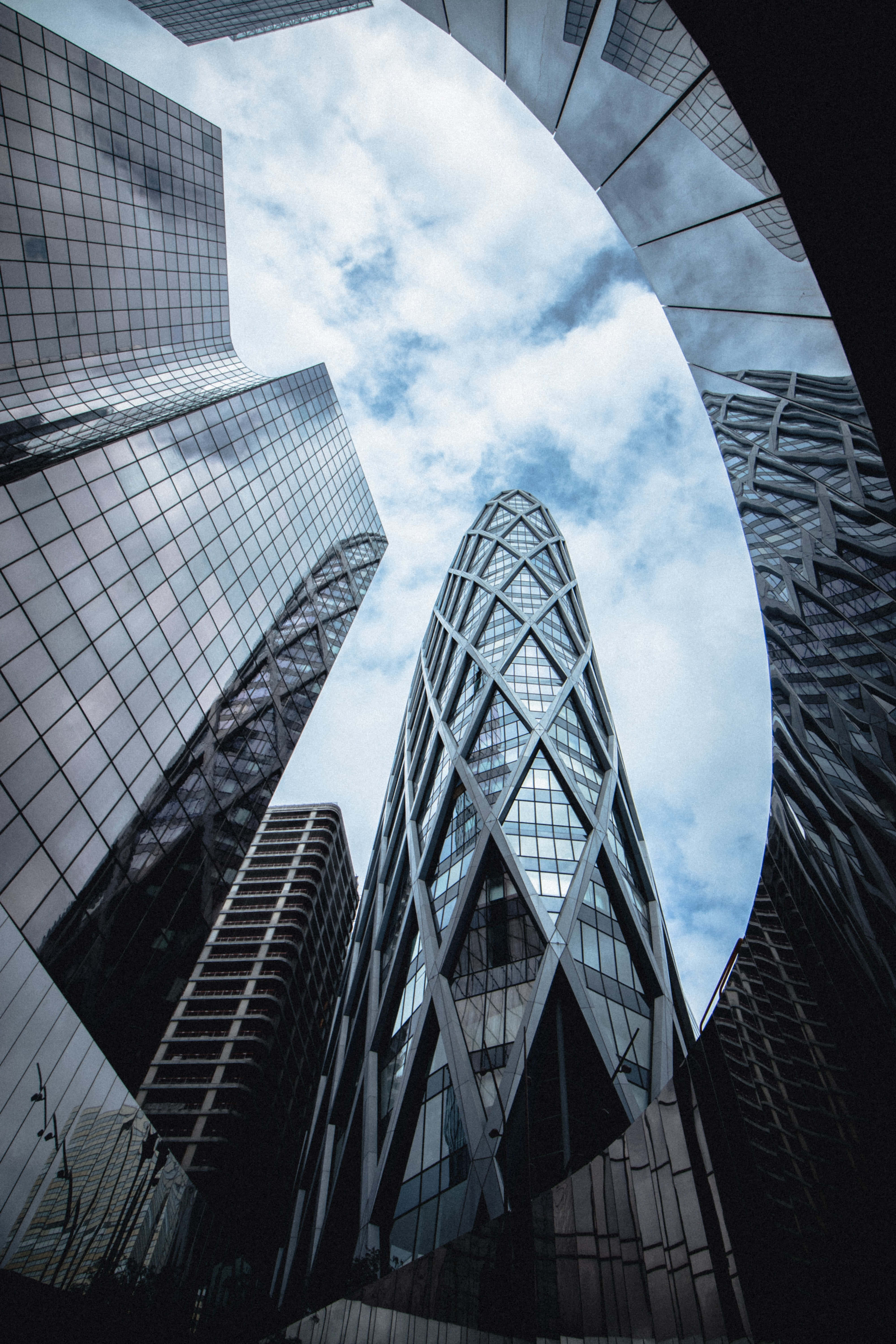 modern glass skyscrapers, cloudy sky, futuristic urban canyon, 5K Phone Wallpaper
