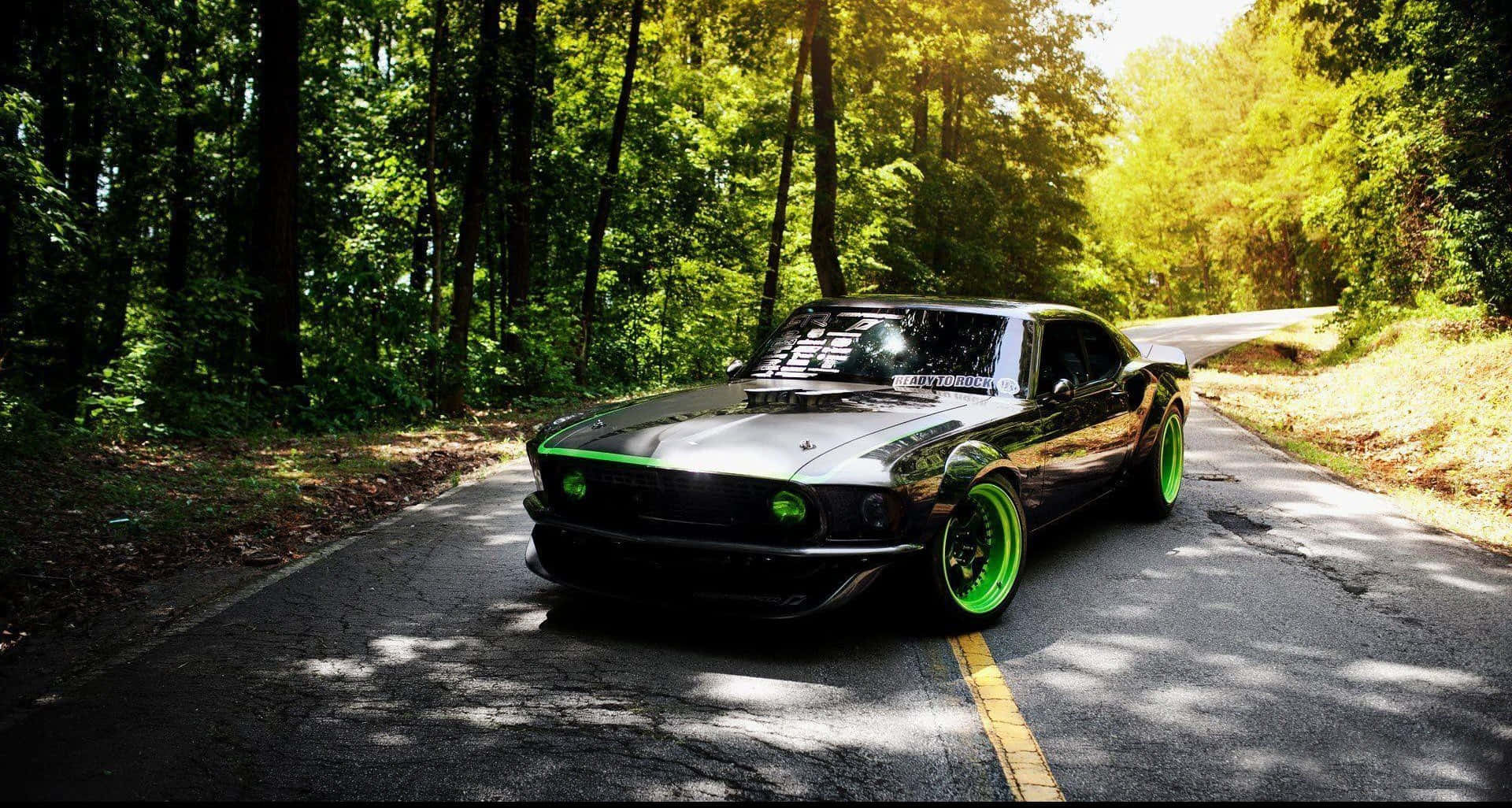 black muscle car, neon green accents, sunlit forest road, Full HD Desktop Wallpaper