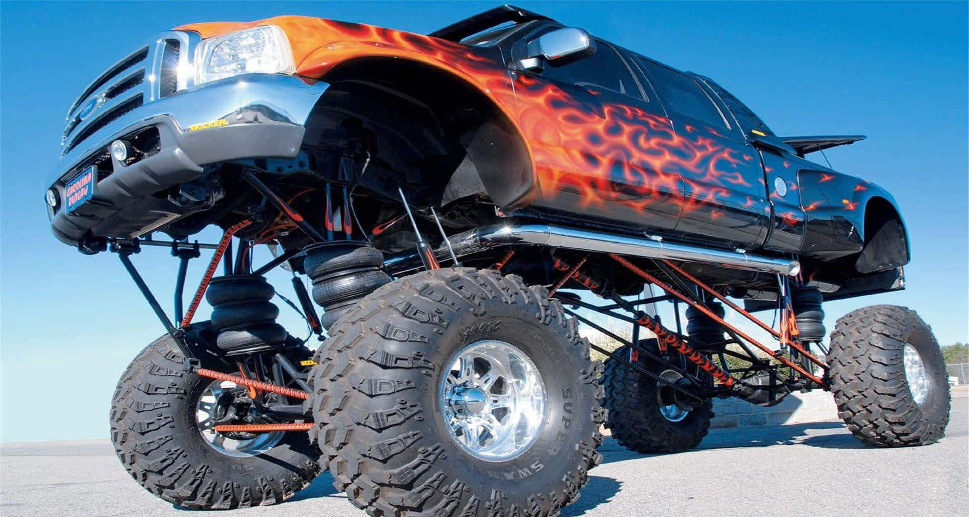 monster truck, fiery orange flame decals, massive tires, Full HD Desktop Wallpaper
